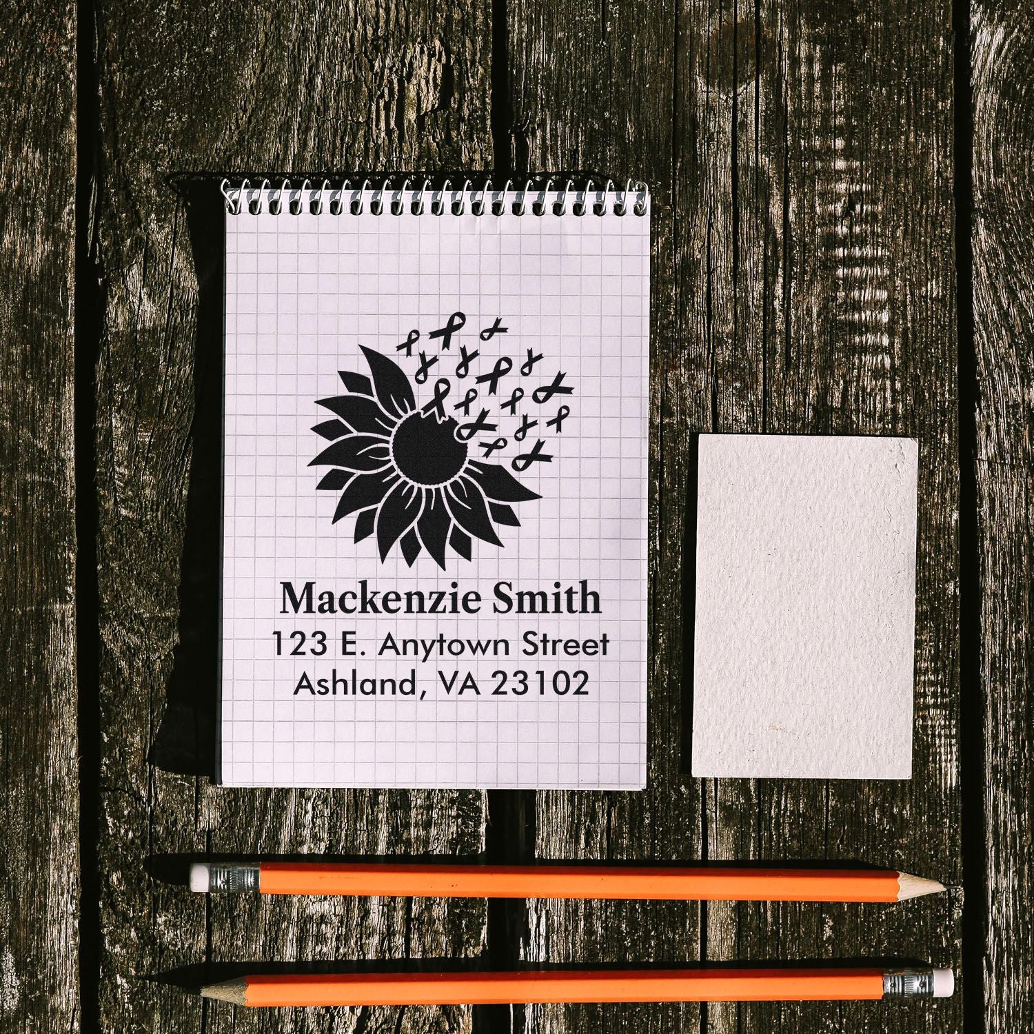 Personalized rubber address stamp with sunflower and ribbon logo for custom name and mailing labels.