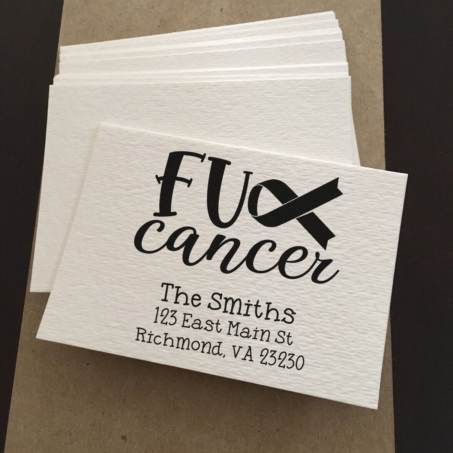 Personalized rubber stamp sample for cancer awareness cards, featuring black ribbon and Smiths return address.