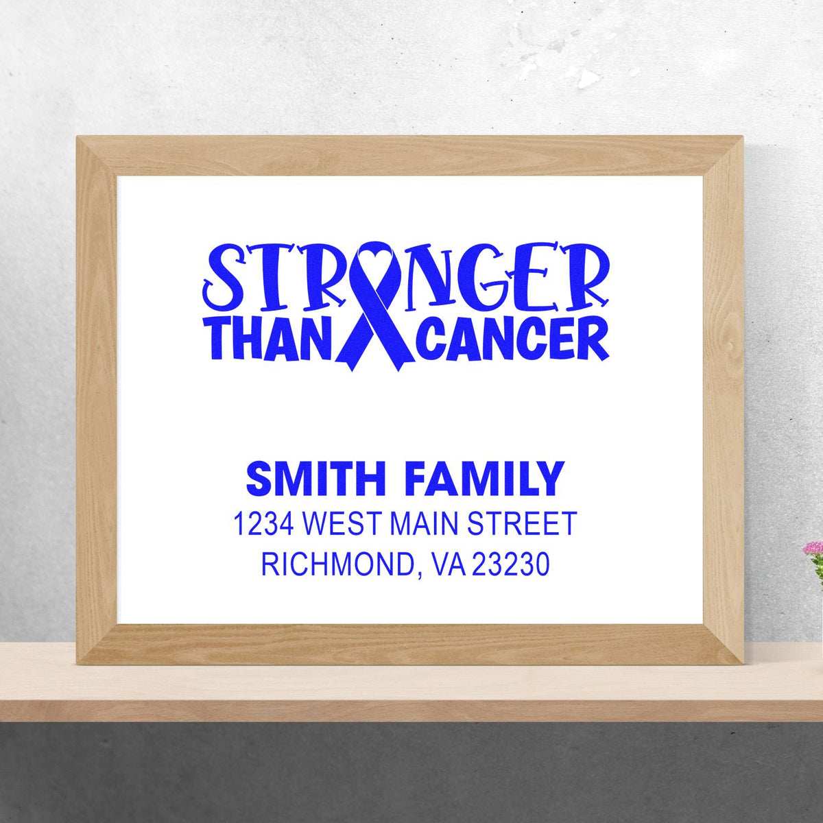 Custom rubber stamp design mockup with Stronger Than Cancer ribbon, Smith family name, and return address for awareness support.
