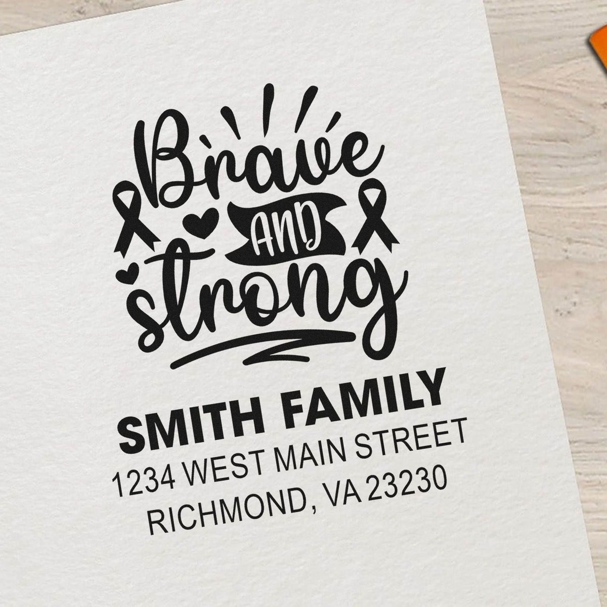Custom rubber stamp with Brave and Strong design, awareness ribbons, and personalized family address for cards and stationery.