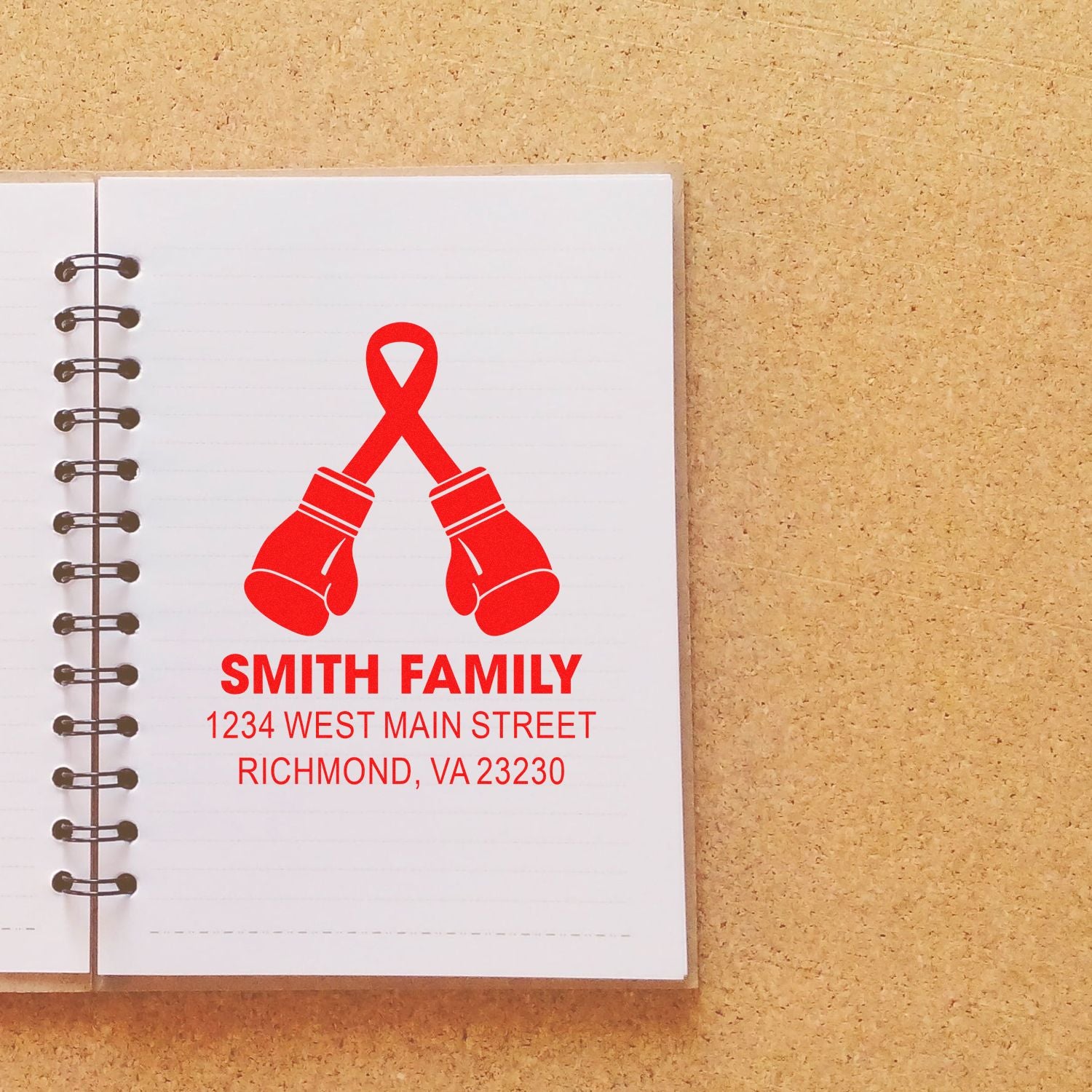 Custom family return address rubber stamp with red boxing gloves logo and Smith Family, Richmond VA address on notebook.