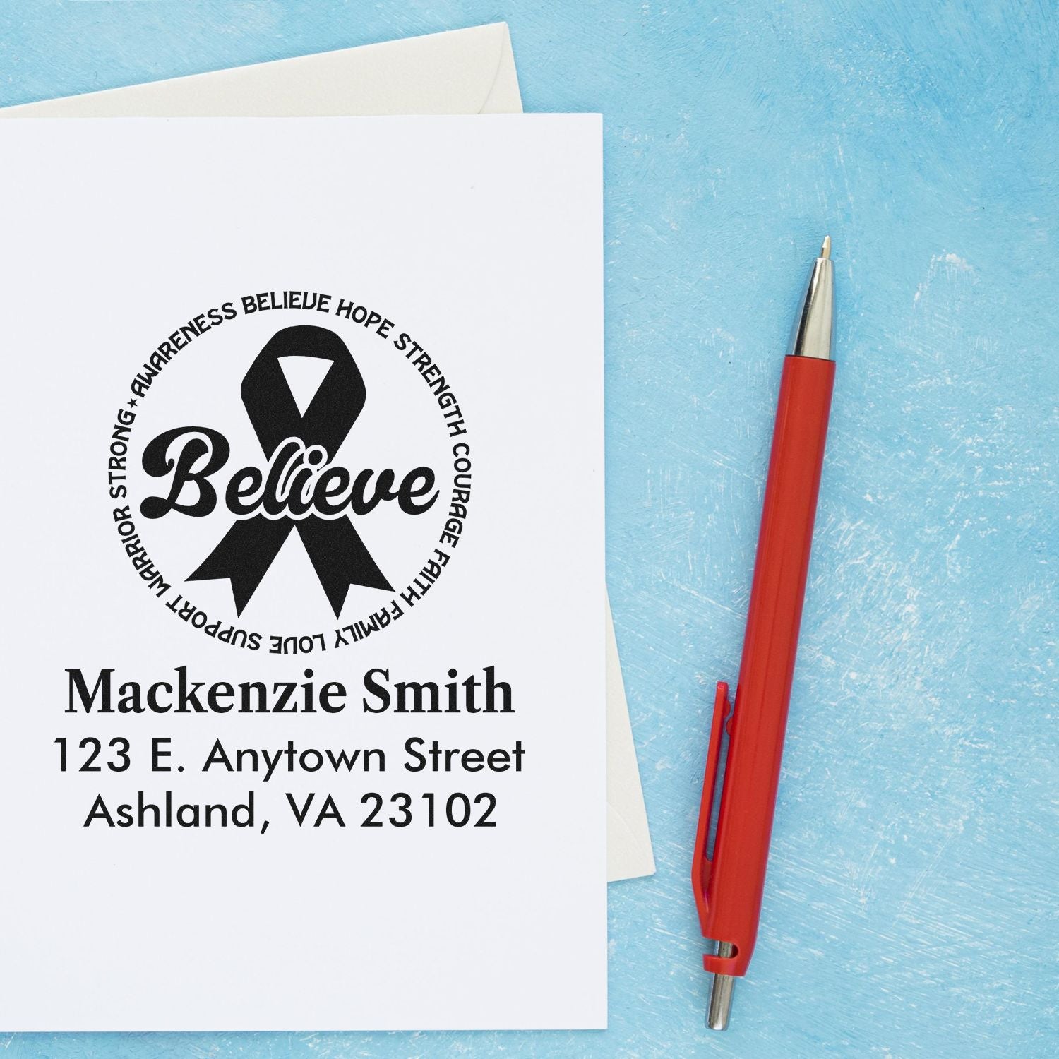 Personalized rubber stamp with awareness ribbon, Believe design, and custom return address for Mackenzie Smith.