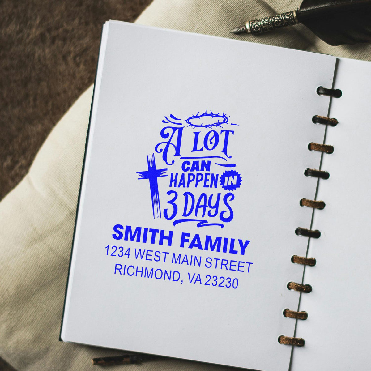 Custom family rubber stamp imprint reading A Lot Can Happen in 3 Days with Smith family address on an open notebook.