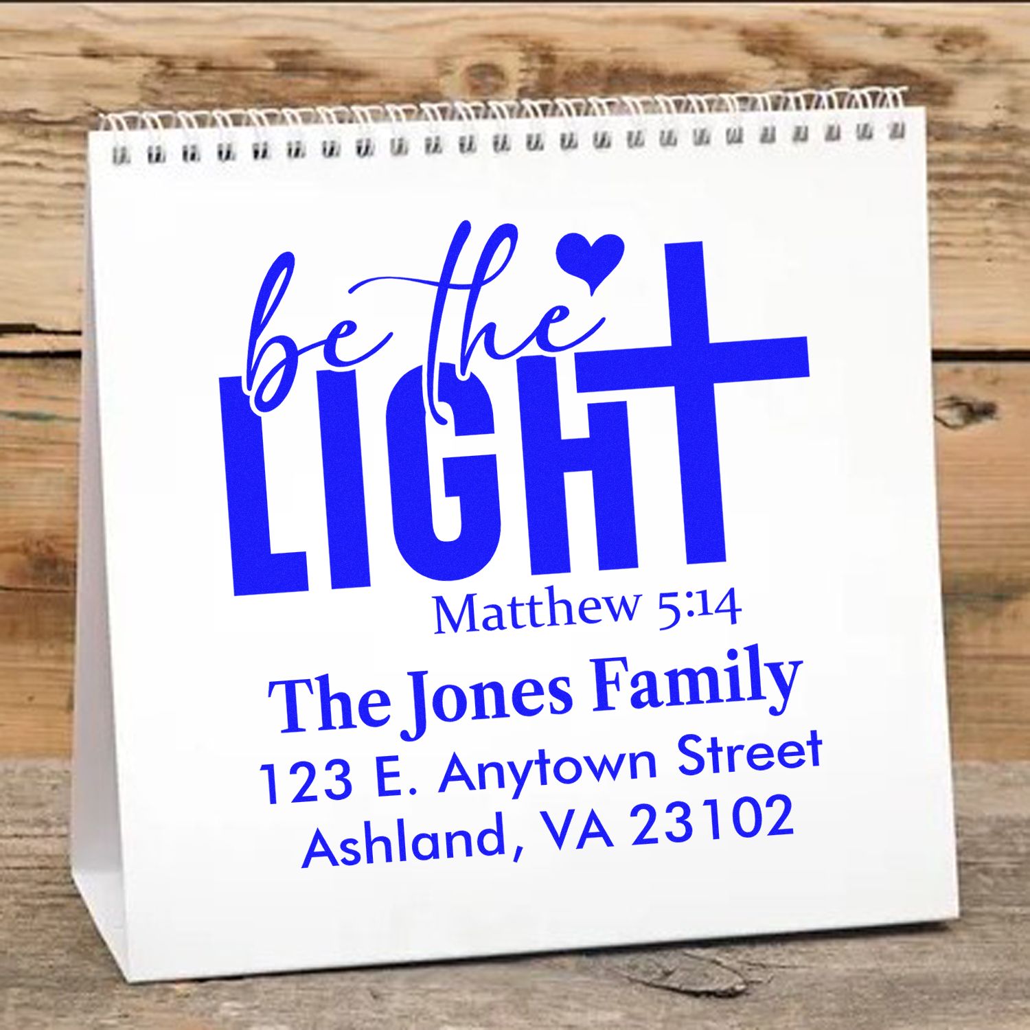 Personalized Christian address rubber stamp with Be the Light Matthew 5:14, family name, and custom address in blue.