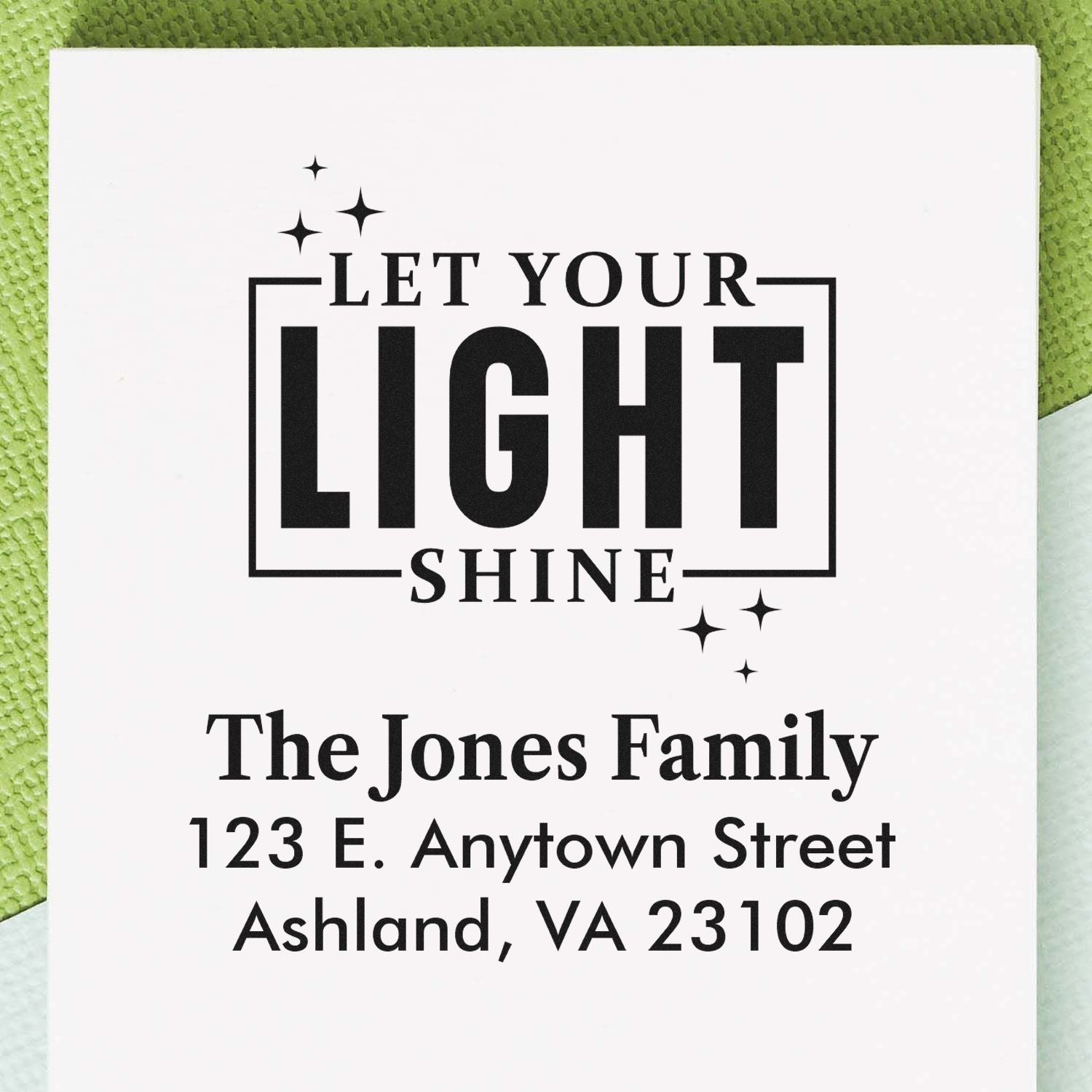 Custom return address rubber stamp with Let Your Light Shine quote, family name, and Ashland, VA address.