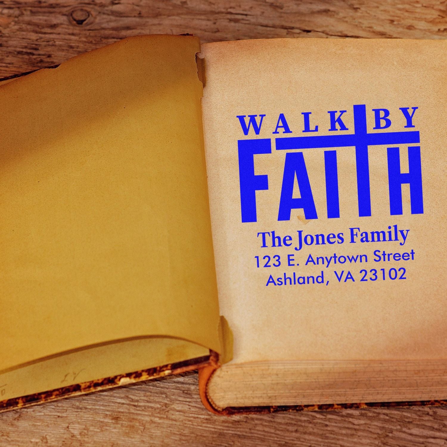 Custom rubber stamp design with Walk By Faith family name and address imprint on an open book.