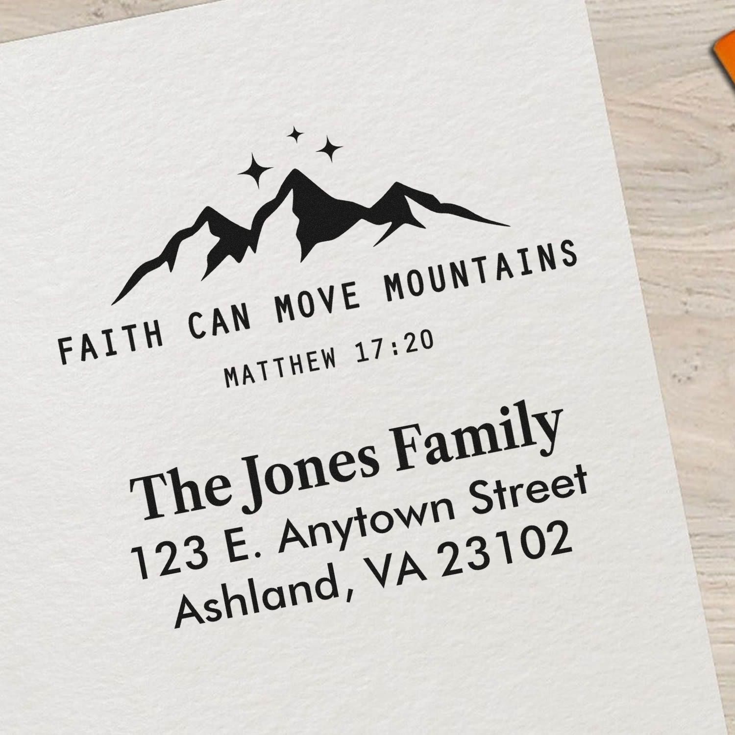 Custom rubber stamp with mountain graphic, Matthew 17:20 scripture, and personalized family address for stationery.