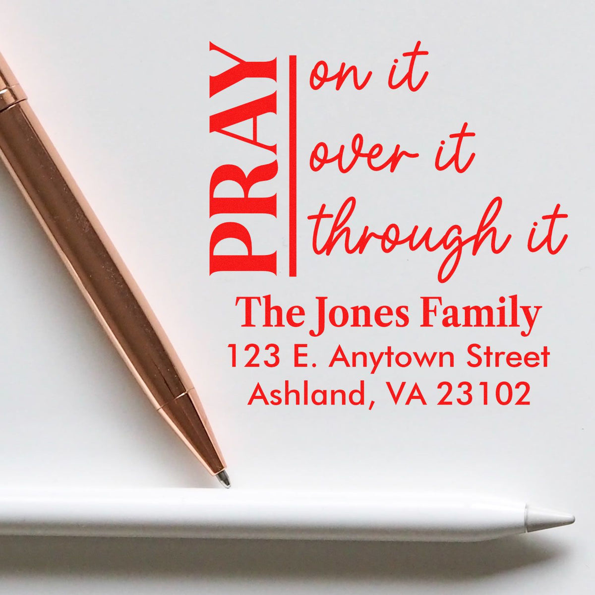 Personalized rubber stamp with Pray on it, over it, through it and custom family name and address for stationery.