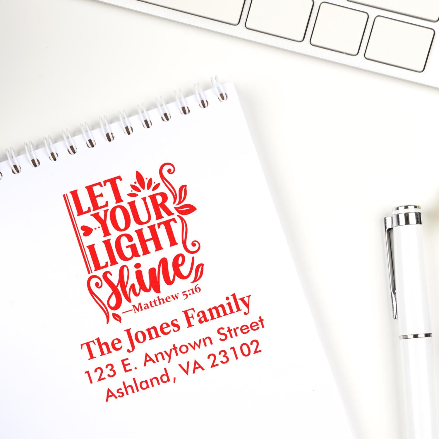 Custom rubber stamp impression with Let Your Light Shine Bible verse and family address for personalized Christian stationery.