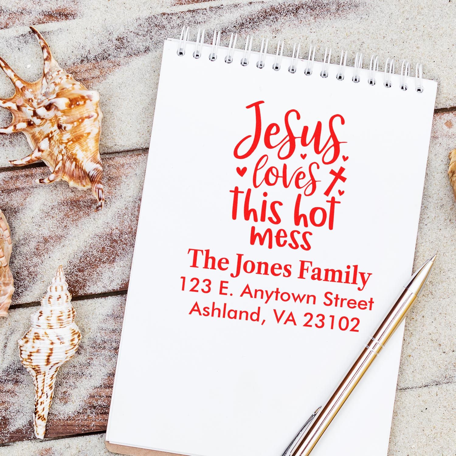 Custom return address rubber stamp with Jesus loves this hot mess design for The Jones Family, shown on notebook mockup.