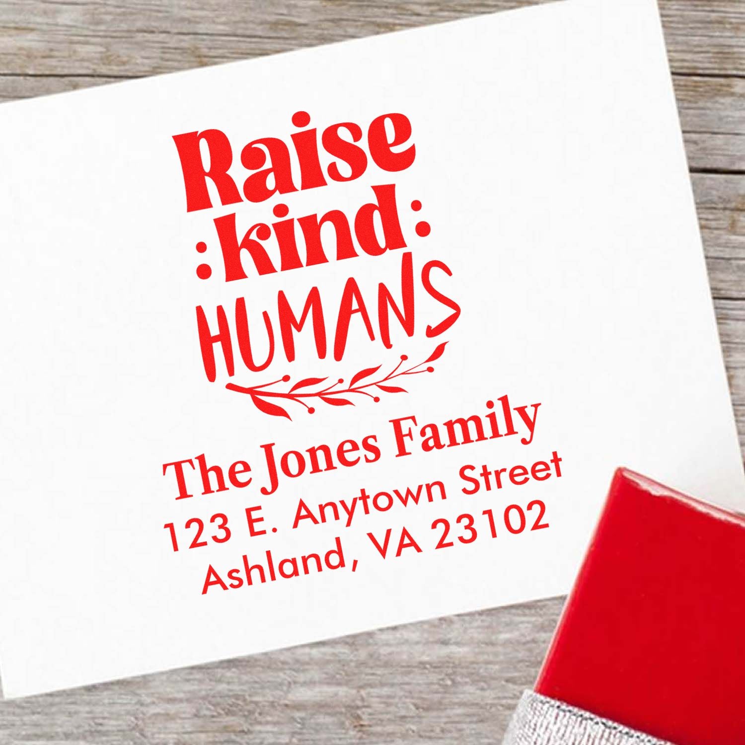 Personalized rubber stamp with Raise Kind Humans quote and custom family return address for home mail.