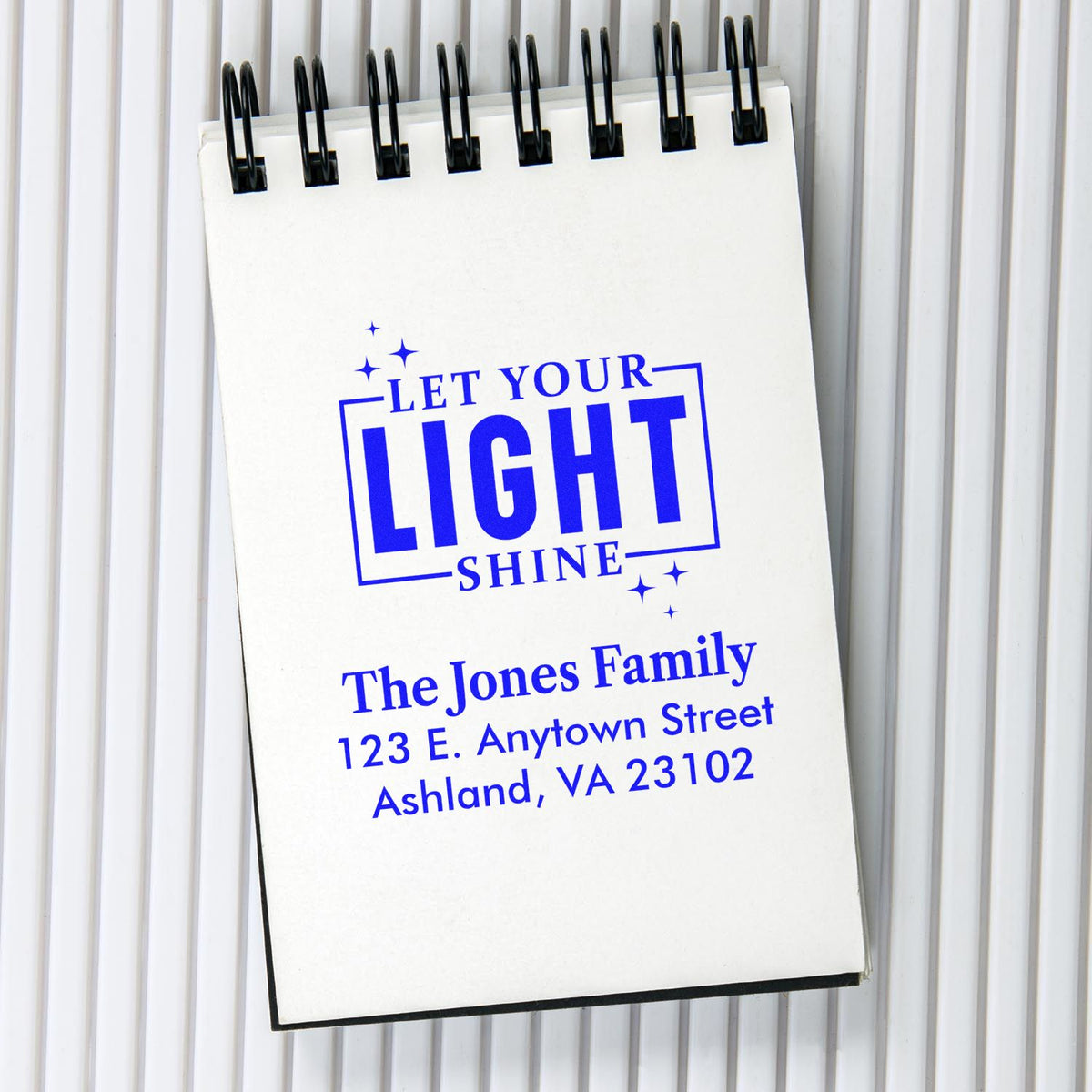 Custom rubber stamp design with Let Your Light Shine and return address for personalized mailing.