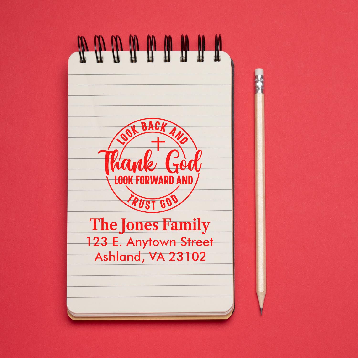 Custom rubber stamp mockup with Christian quote and family return address for personalized envelopes.