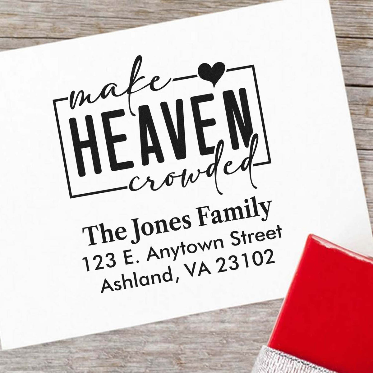 Custom rubber address stamp with Make Heaven Crowded design, family name, and return address for personalized mailing.