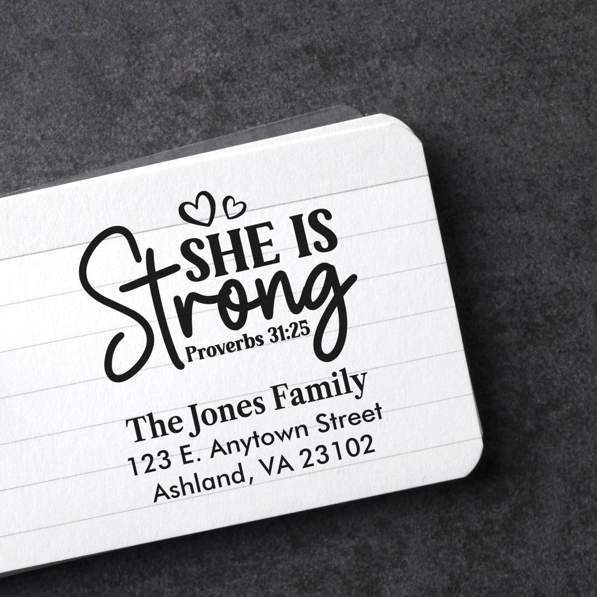 Custom rubber stamp with Proverbs 31:25 She is Strong and personalized family return address for faith-based stationery.