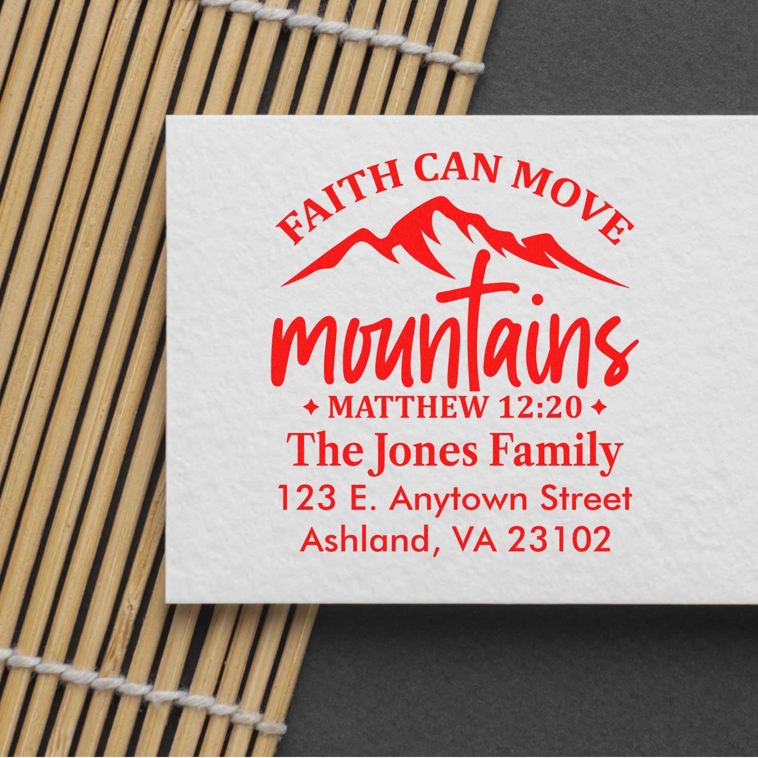 Custom Christian return address rubber stamp reading Faith Can Move Mountains with mountain and cross design for The Jones Family