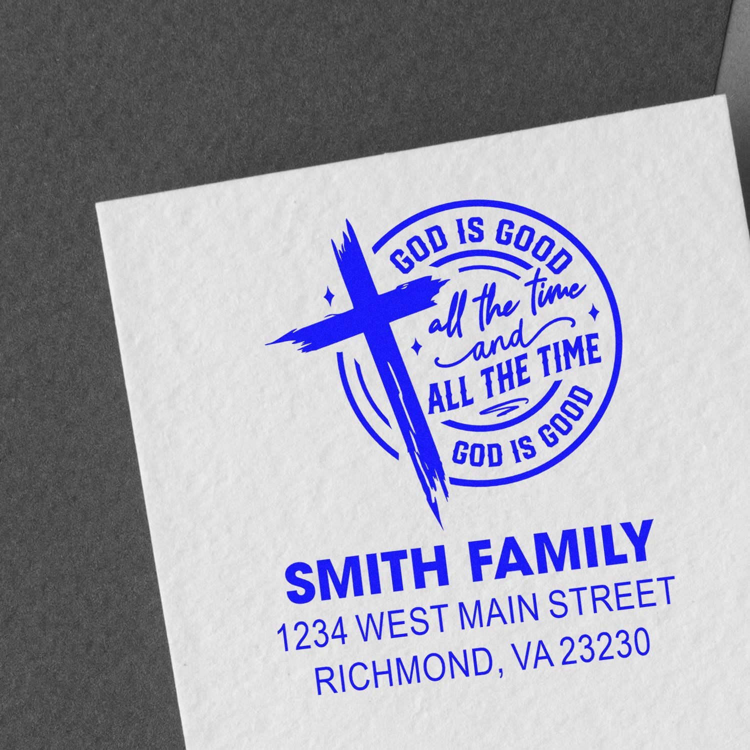 Custom personalized rubber stamp with Christian cross, God is good all the time slogan, and family return address in blue ink.