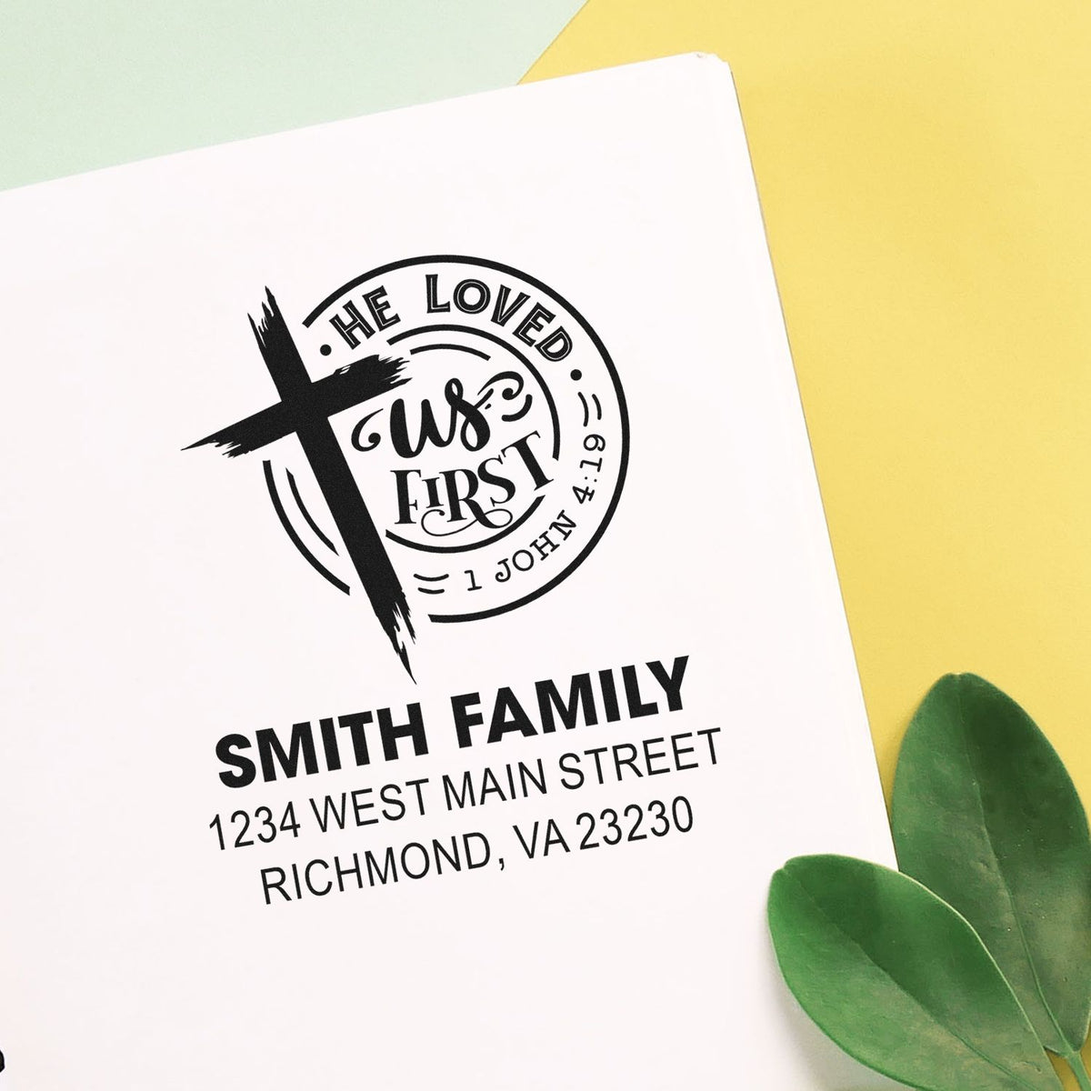 Custom Christian rubber address stamp with cross and He Loved Us First Bible verse, personalized Smith Family return address.