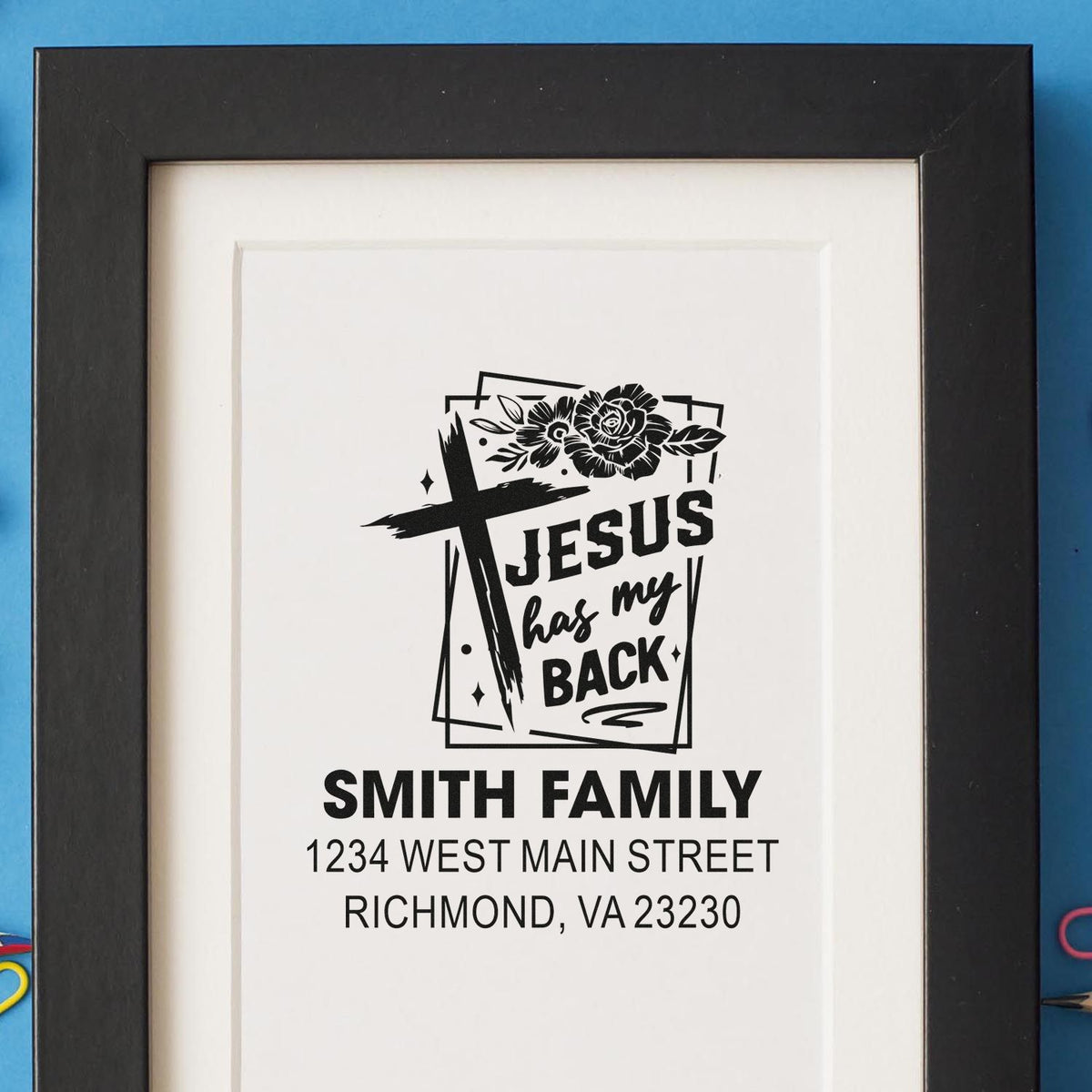Custom rubber stamp design with Jesus Has My Back cross, floral art, and personalized Smith family return address.