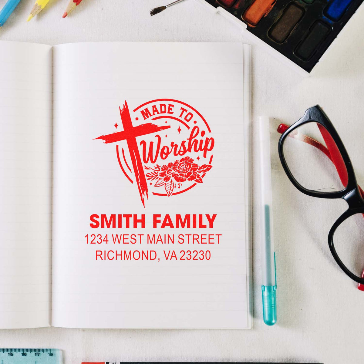Custom rubber stamp mockup on notebook with Made to Worship design, Smith Family name, and address.