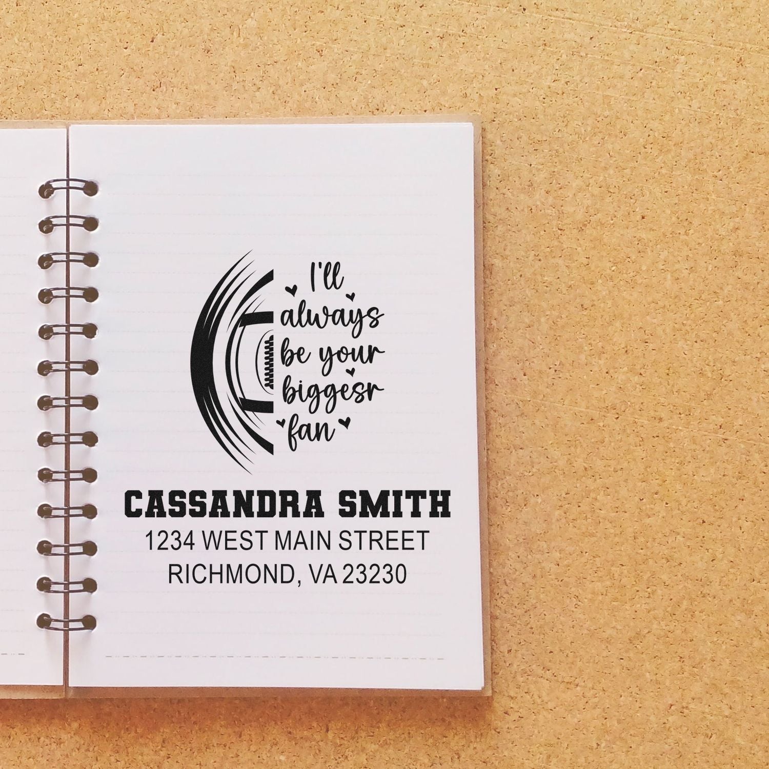 Custom rubber stamp design with Ill always be your biggest fan and personalized name and address on a notebook page.