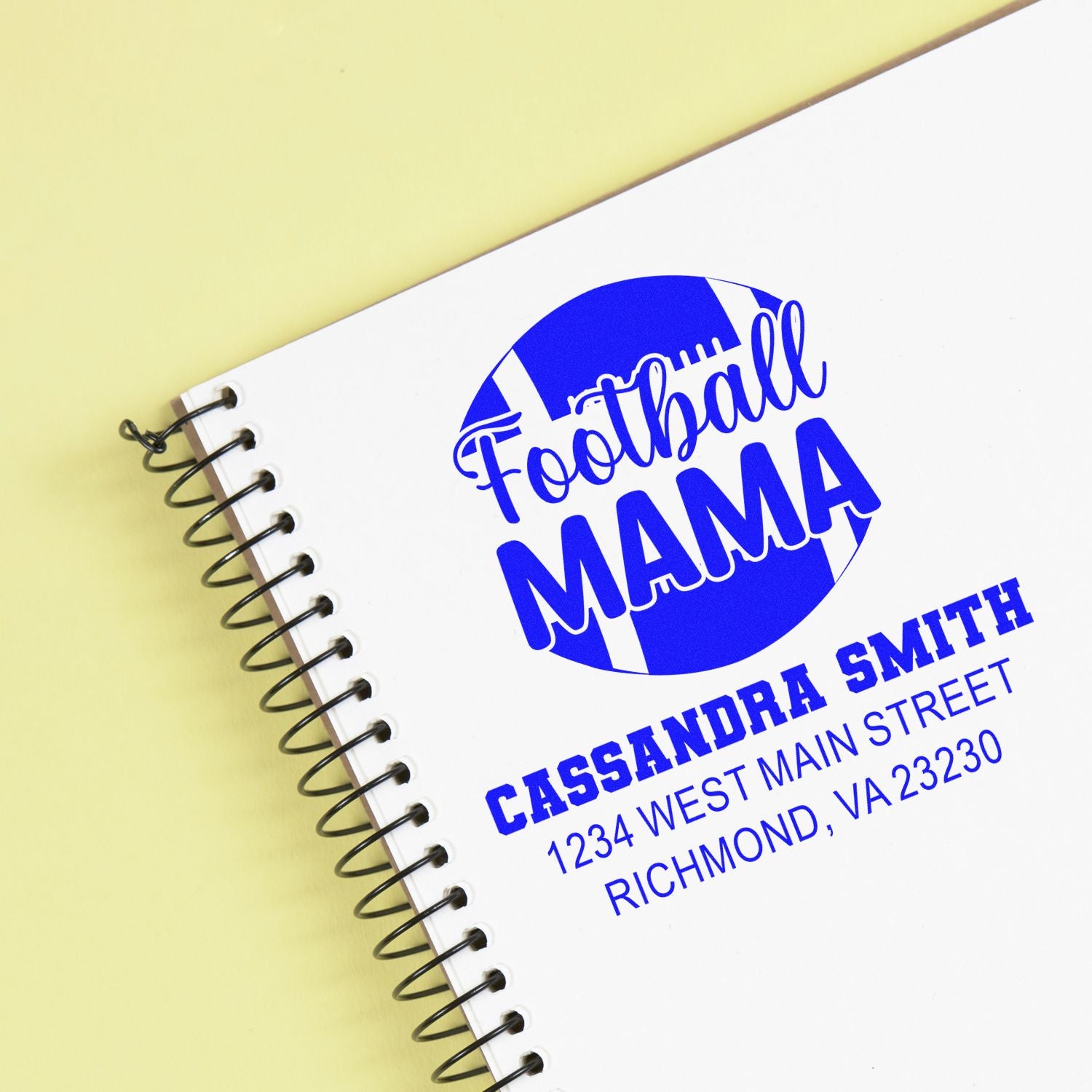 Custom football mama rubber stamp with name and Richmond, VA address on a spiral notebook