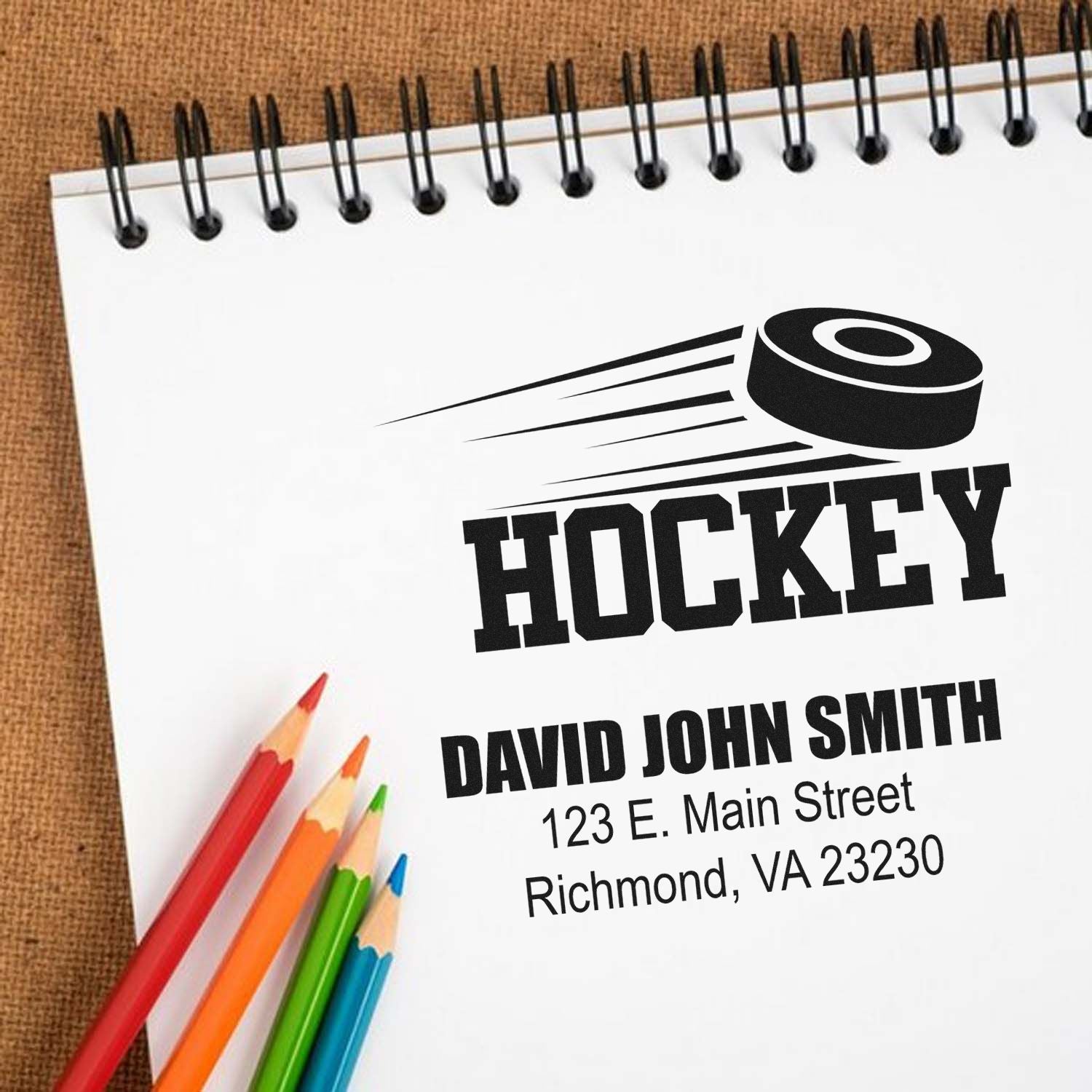 Custom hockey rubber stamp design with personalized name, address, and logo for stationery branding.