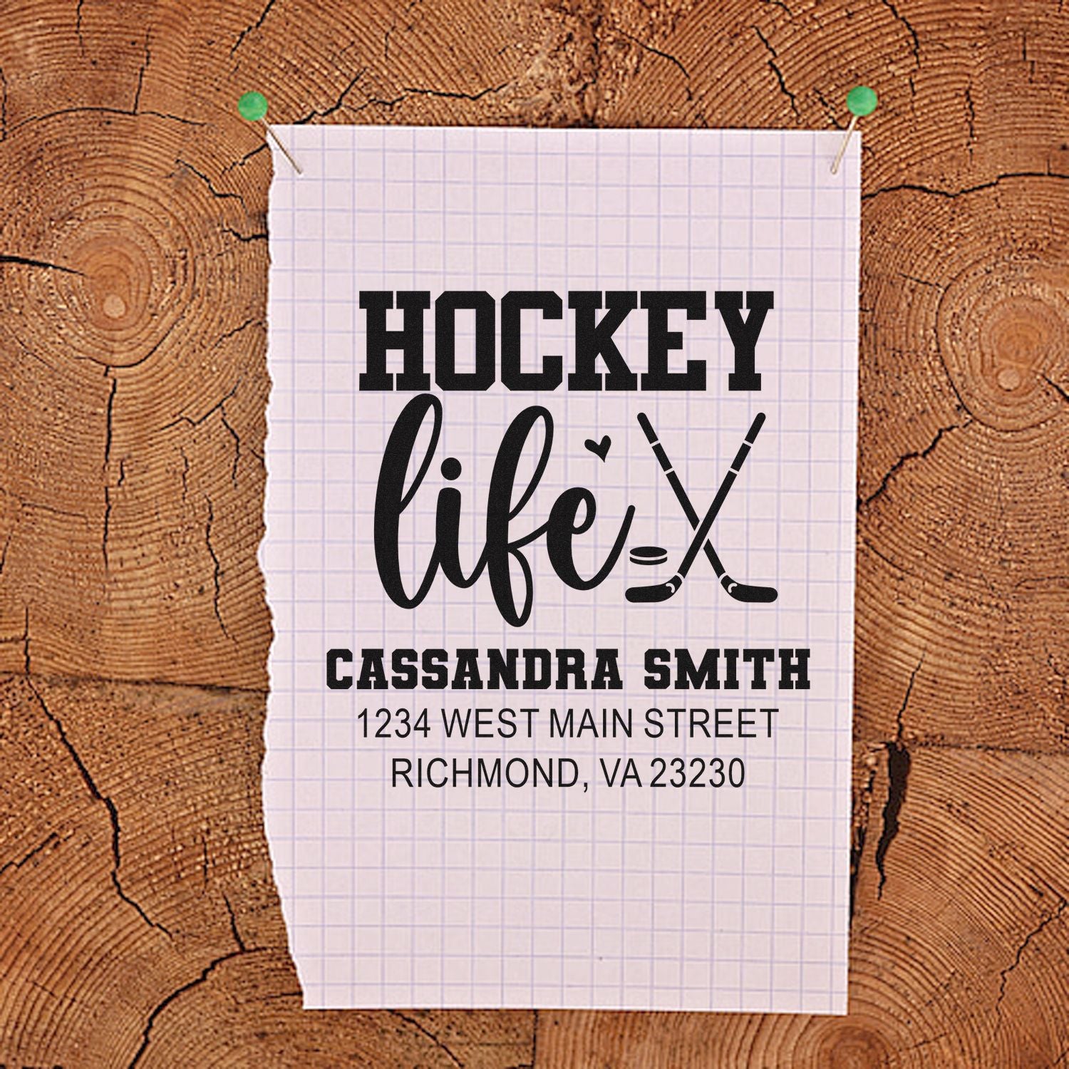 Custom hockey life address rubber stamp design with crossed sticks, name, and address on rustic wood background.