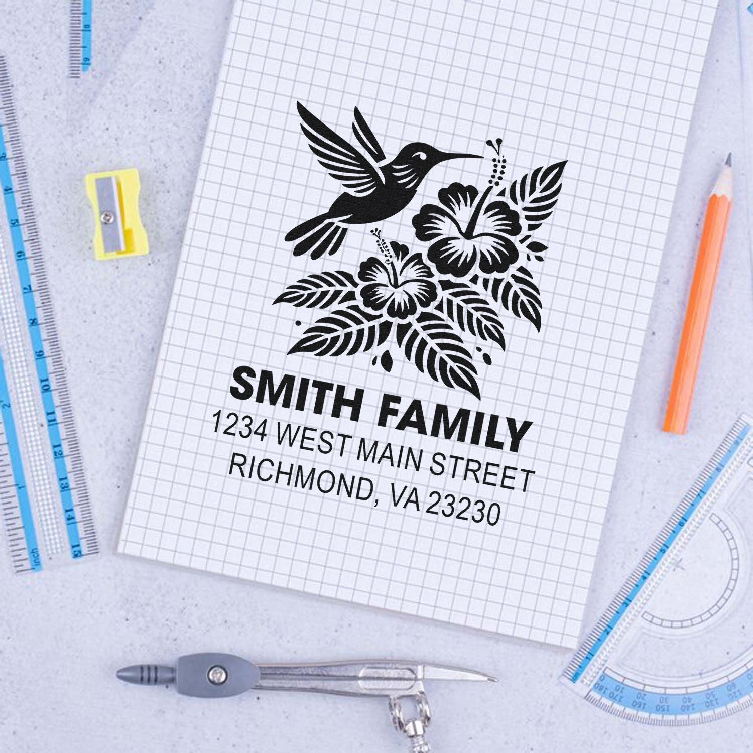 Custom family return address rubber stamp with hummingbird and hibiscus floral design for personalized mailing use.