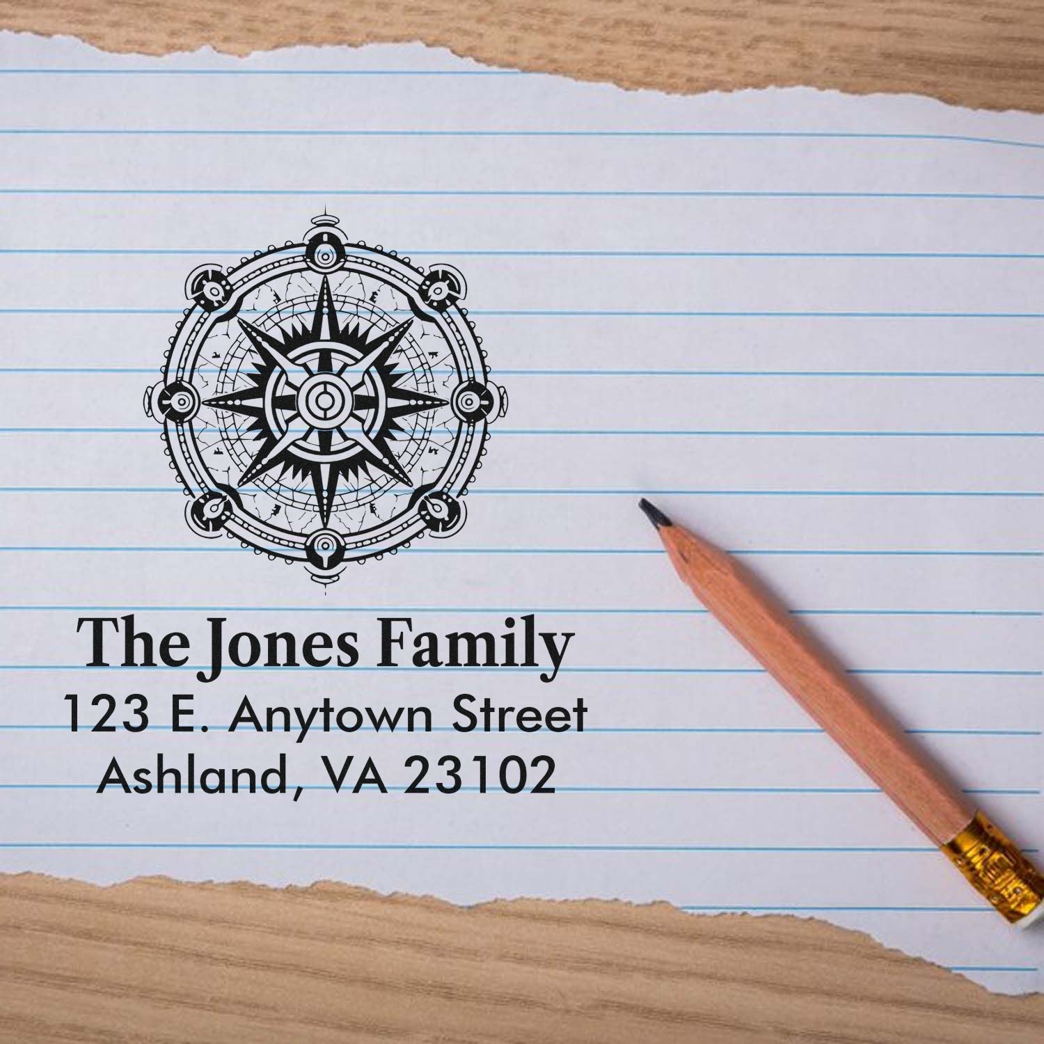 Custom family return address rubber stamp with nautical compass design, showing The Jones Family address on lined paper.