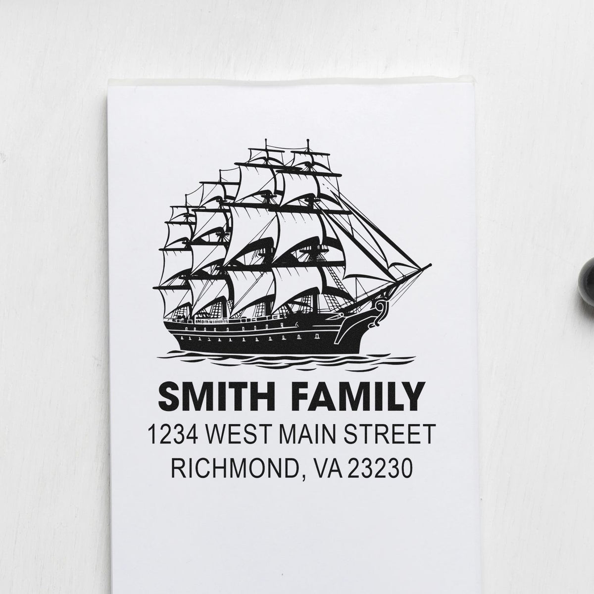 Custom family return address rubber stamp with sailing ship design and Smith Family address in Richmond, VA.