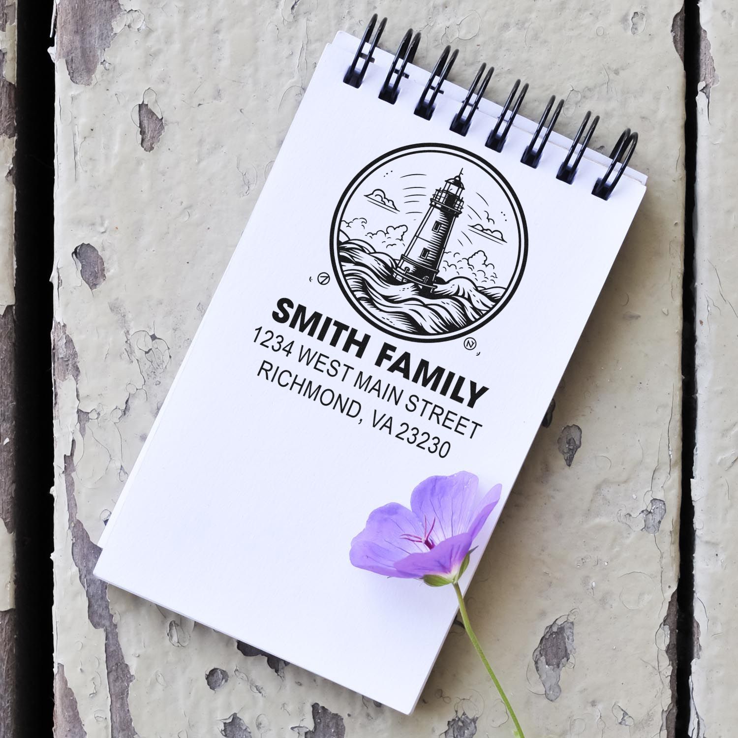 Custom rubber return address stamp for Smith Family, featuring a lighthouse logo and Richmond, VA address on a notebook.