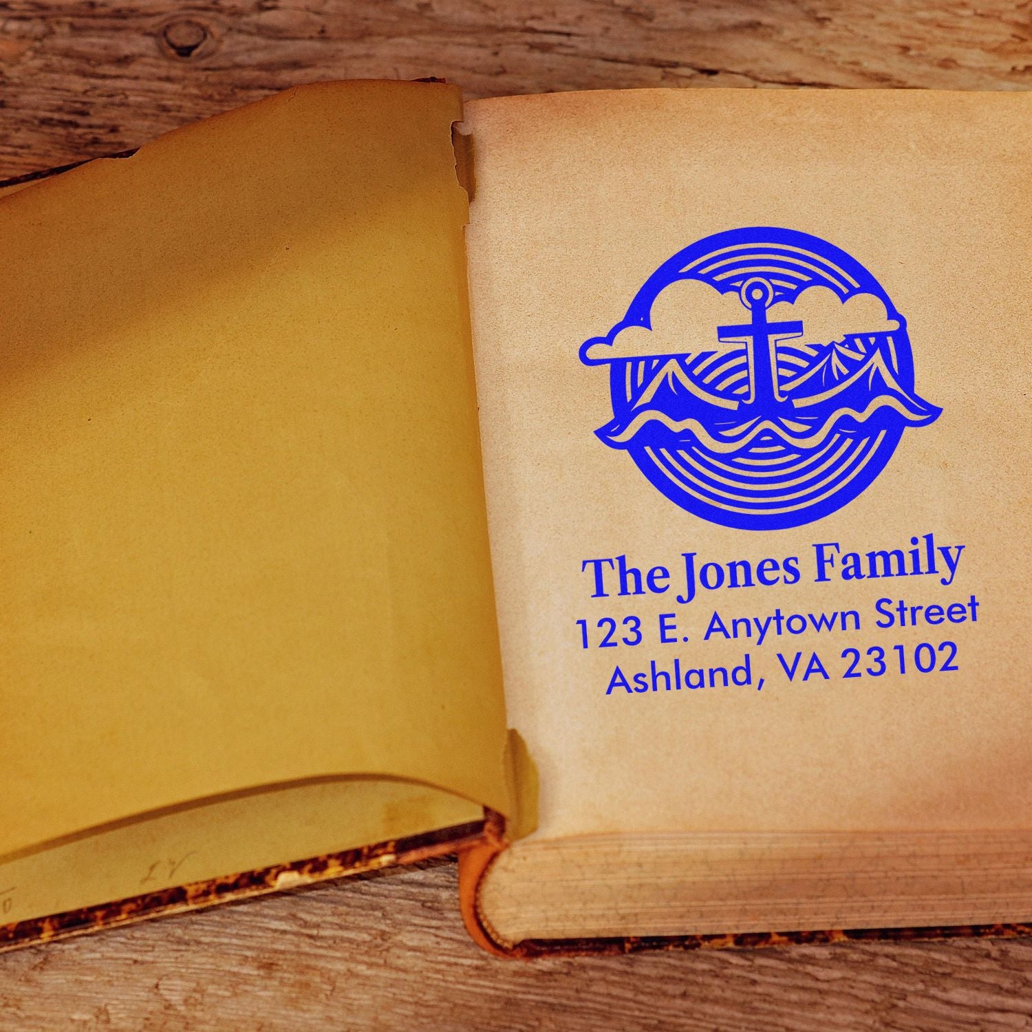 Custom family address rubber stamp with nautical anchor design on open book, perfect for personalized stationery and mailings