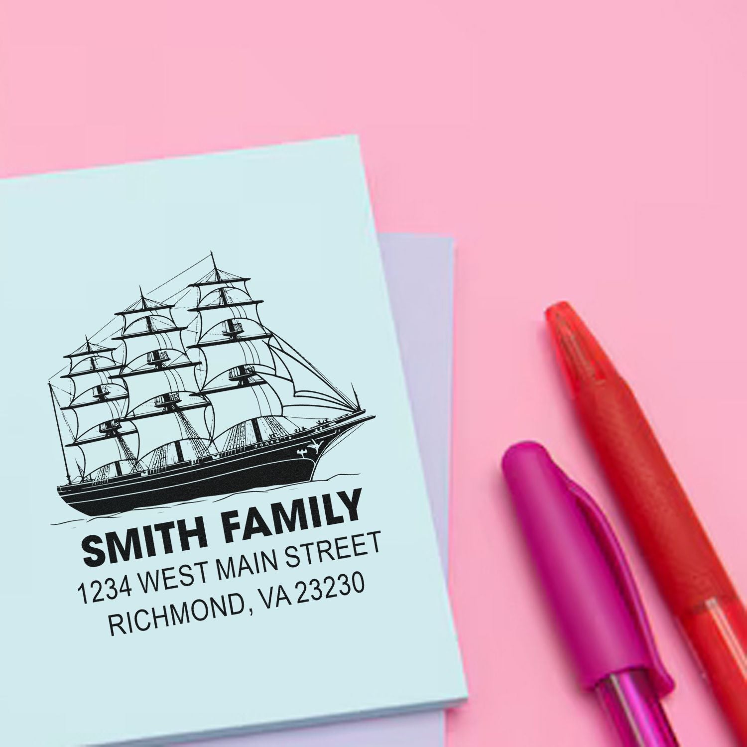 Custom rubber stamp with sailing ship design and family return address for personalized stationery.