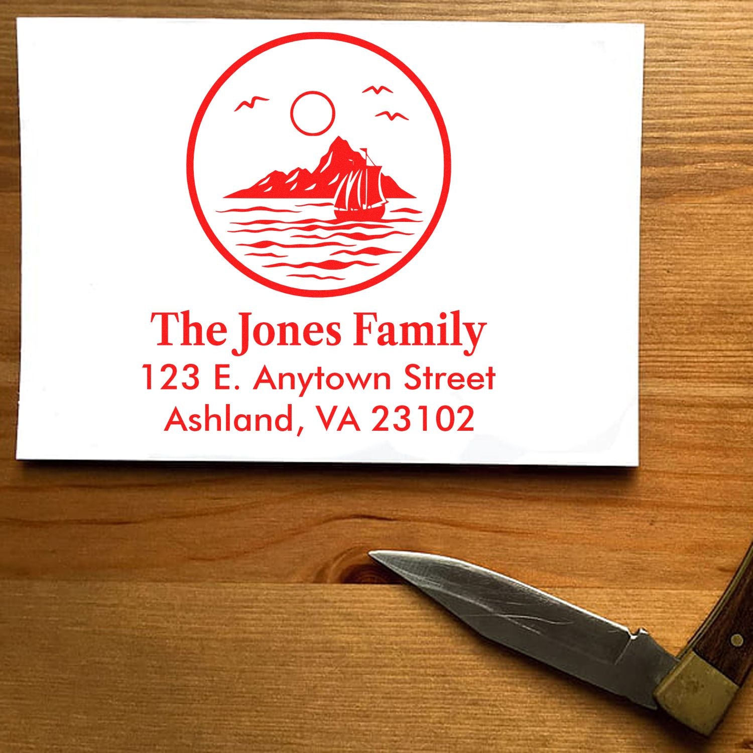 Personalized return address rubber stamp with nautical sailboat logo, family name, and custom address.