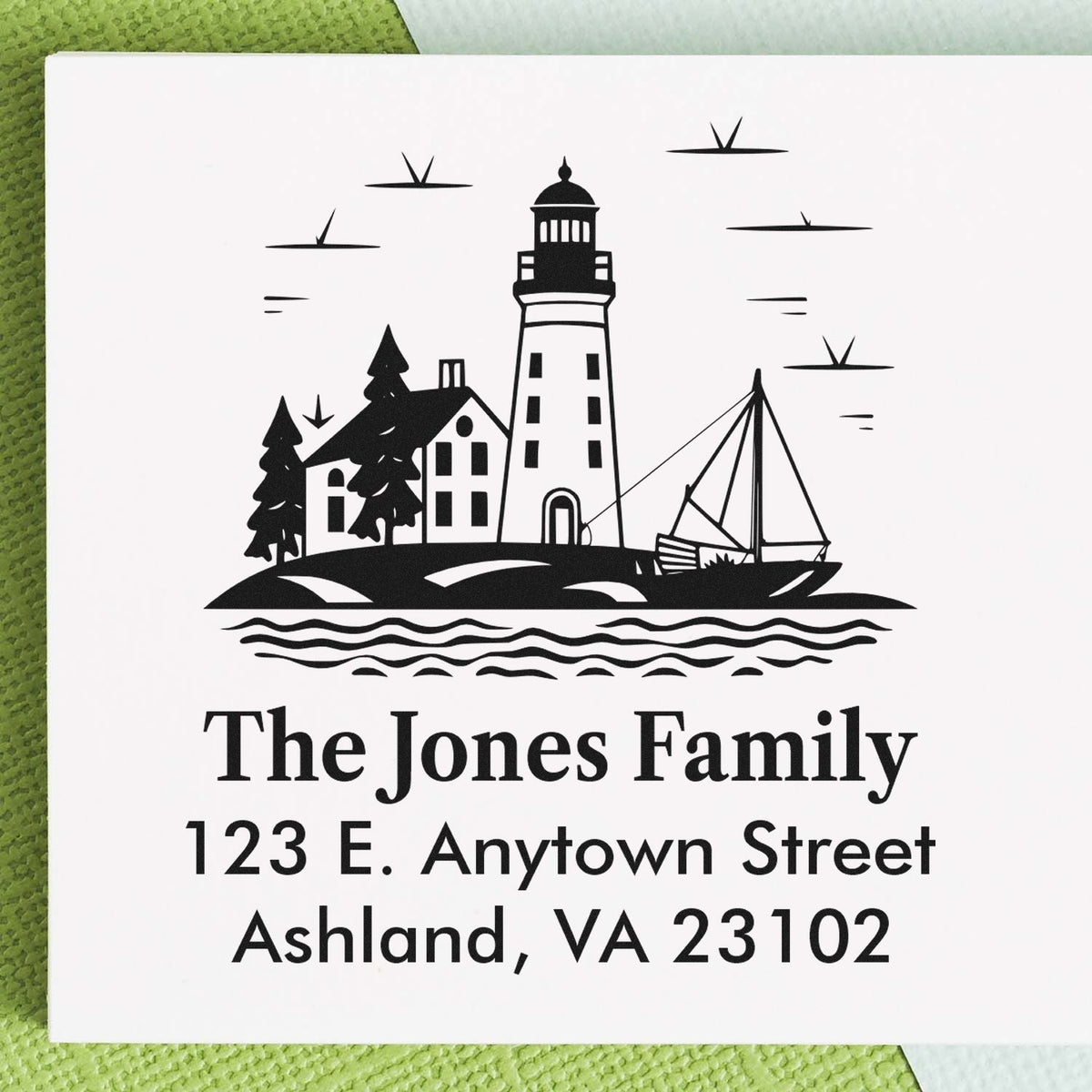 Custom rubber address stamp with lighthouse, sailboat and house design for The Jones Family, 123 E. Anytown Street, Ashland, VA.