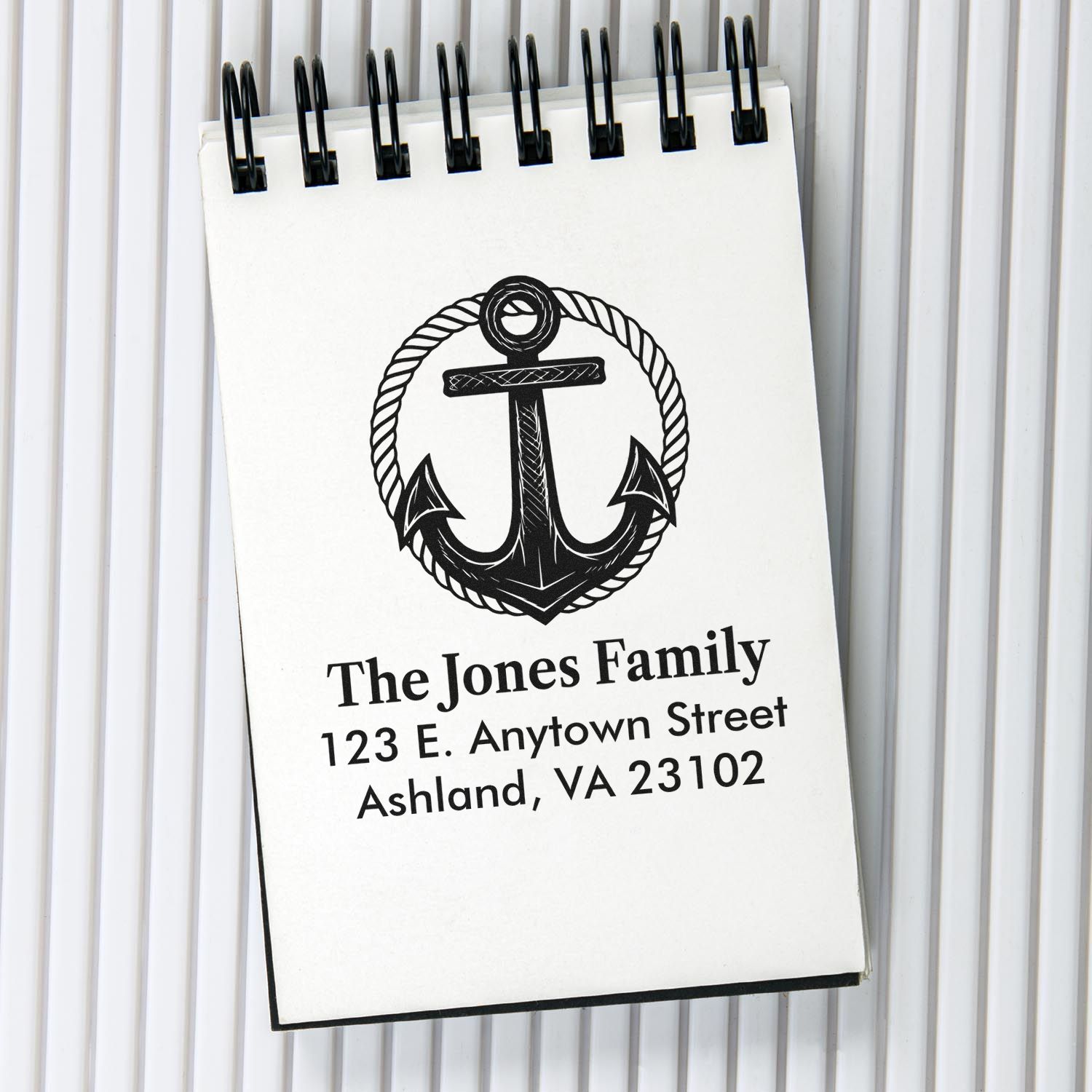 Custom family address rubber stamp with nautical anchor design for personalized return envelopes and stationery.