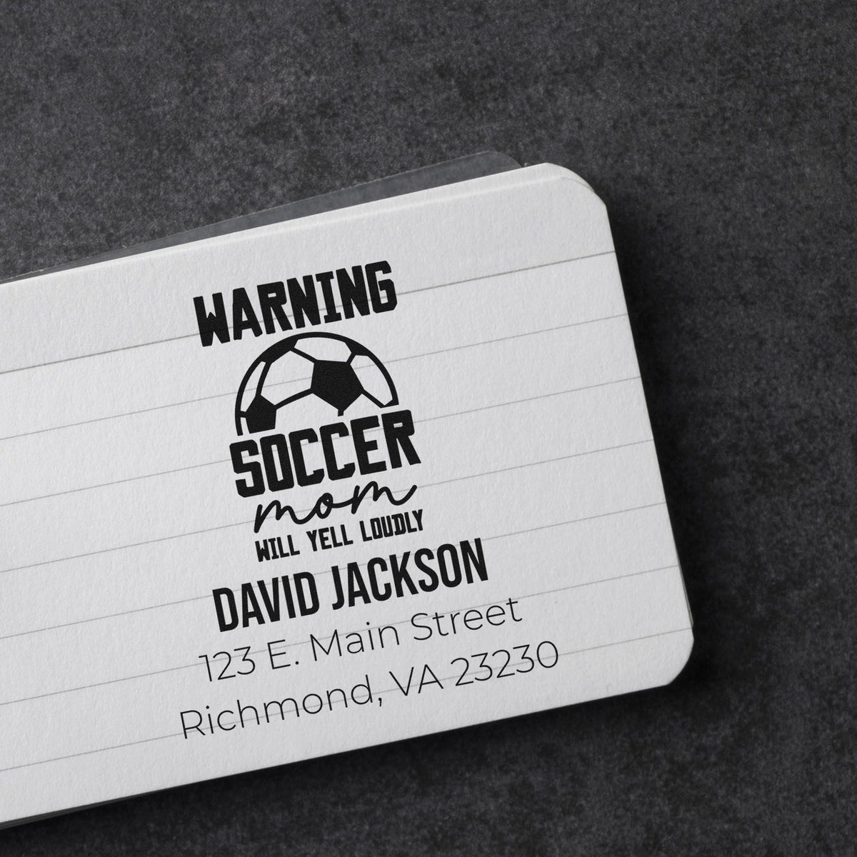 Custom rubber stamp mockup for a Warning Soccer Mom Will Yell Loudly address stamp with name and Richmond, VA address.