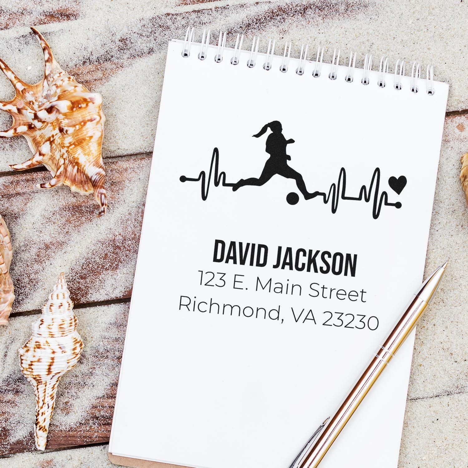 Custom soccer return address rubber stamp with heartbeat design, personalized name and address on notepad mockup.