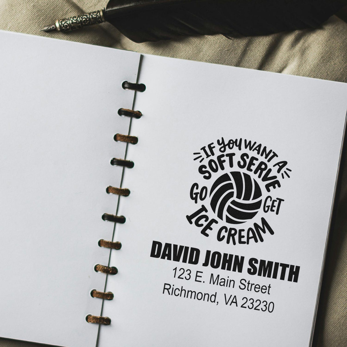 Custom rubber stamp imprint on a notebook page with soft-serve ice cream slogan, name, and address.