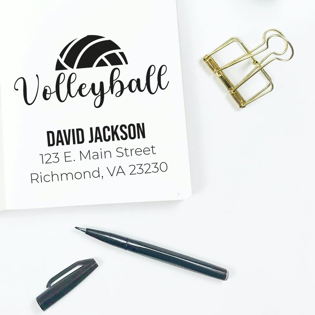 Custom return address rubber stamp with volleyball design, name, and address for personalized stationery and mailing.