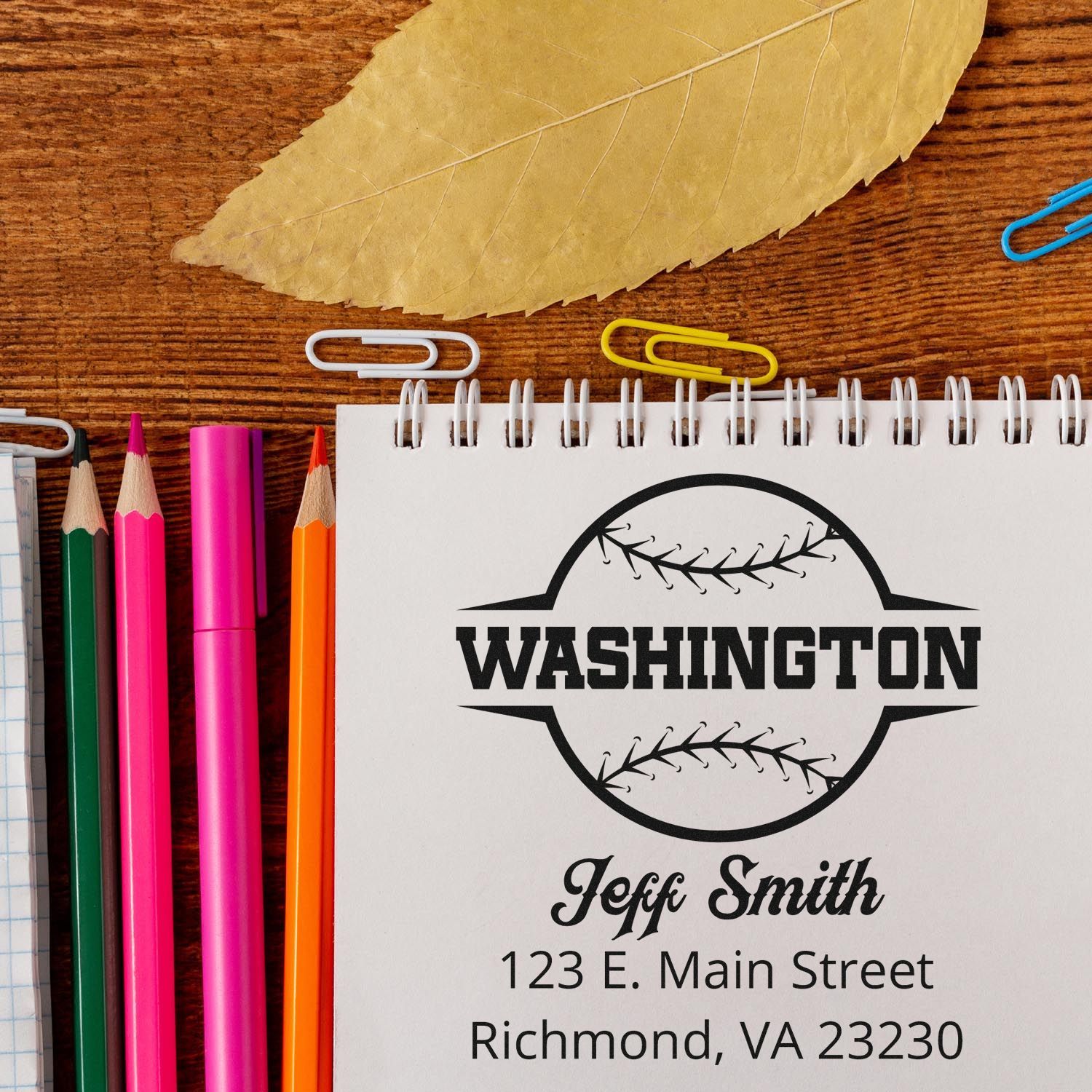 Custom baseball rubber stamp design with Washington logo, name, and address on a notebook for personalized stationery.