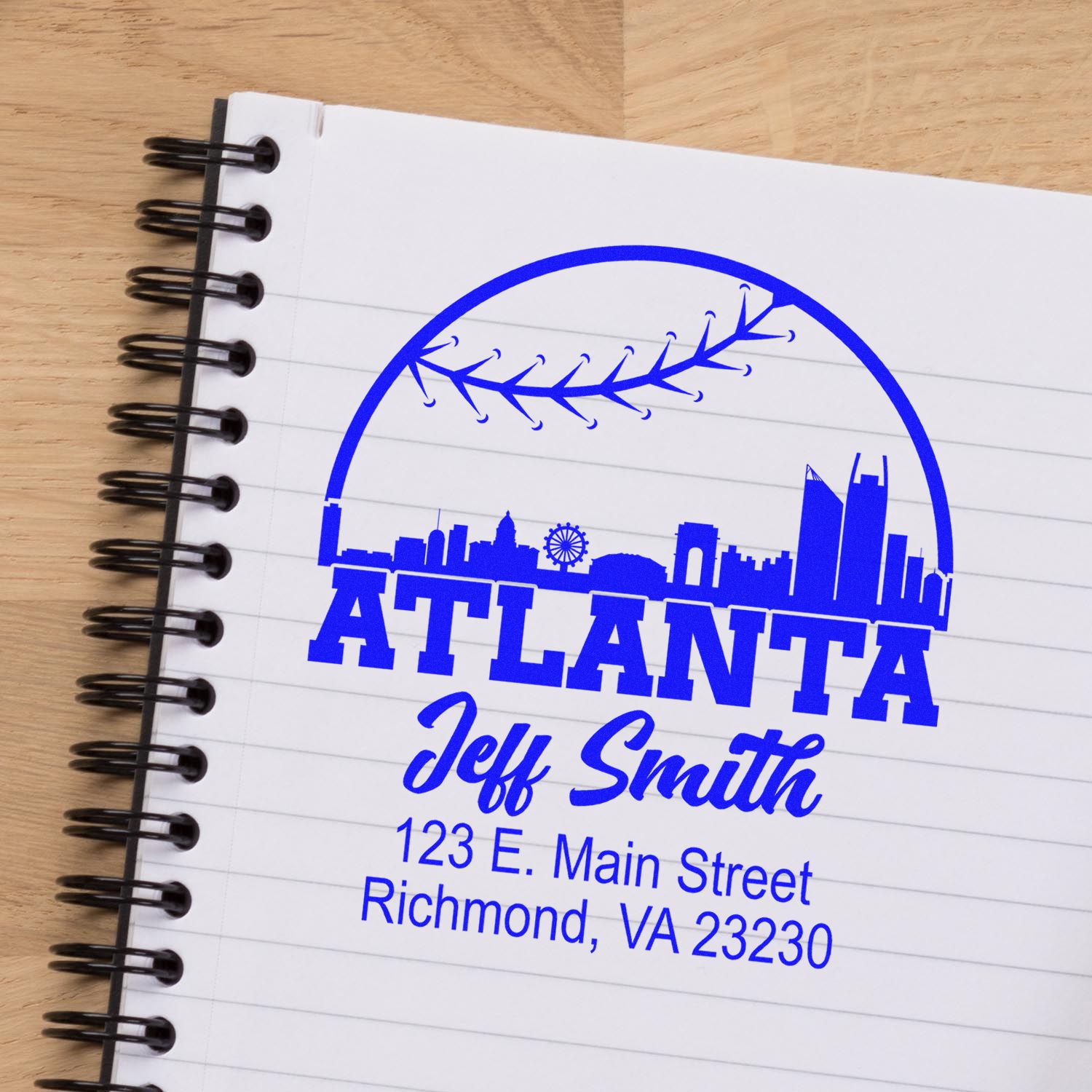 Custom Atlanta address rubber stamp with skyline, Jeff Smith, and mailing address on a notebook page.