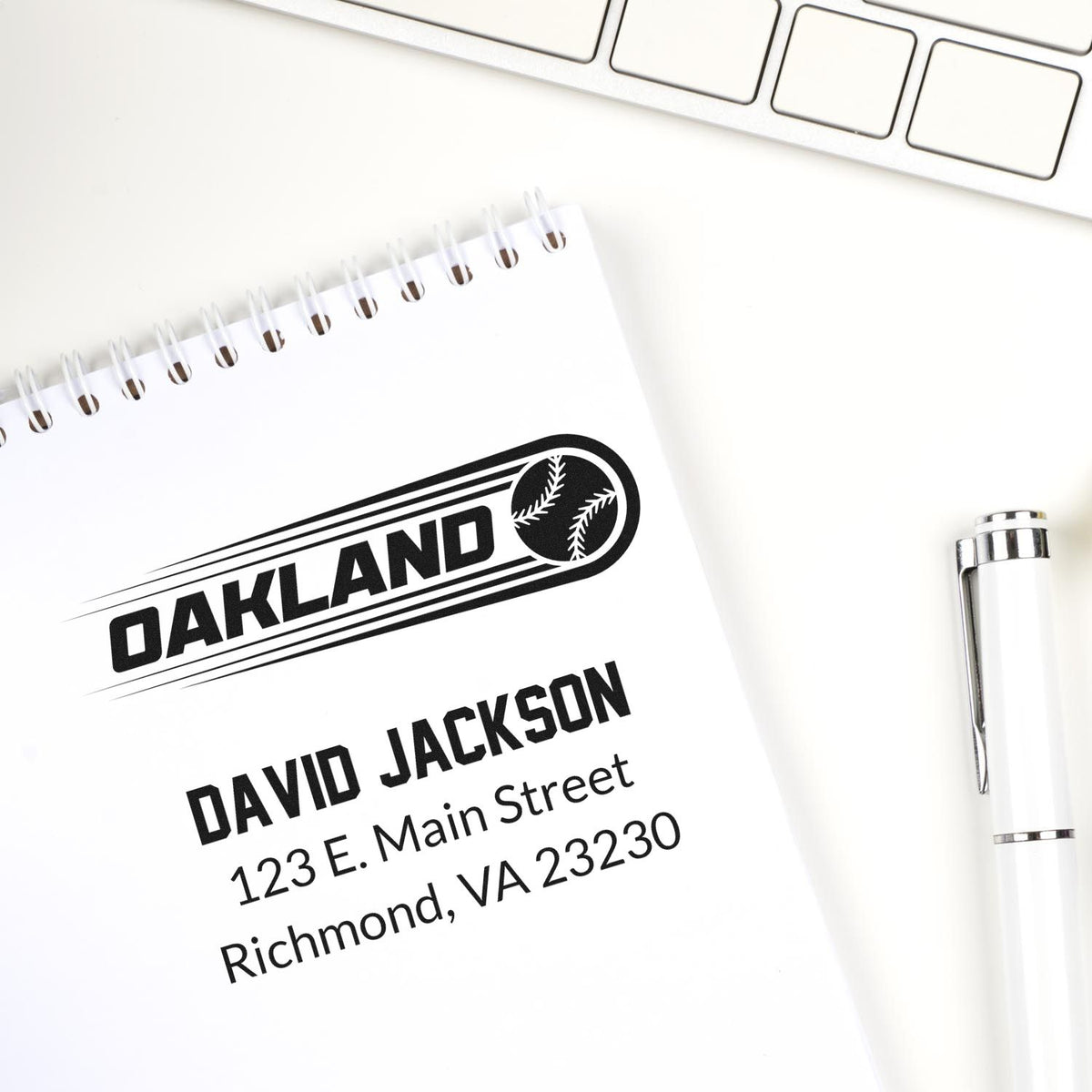 Custom Oakland baseball return address rubber stamp with name, street address, and Richmond, VA imprint on notebook.