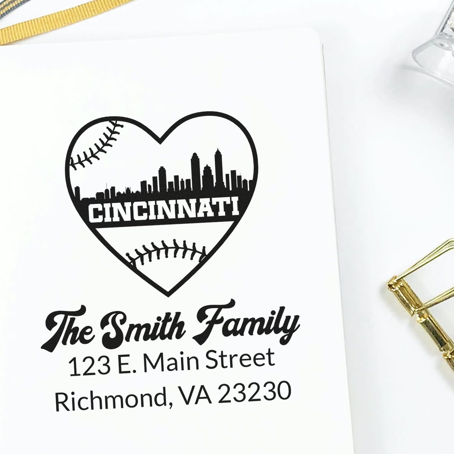 Custom rubber stamp impression with Cincinnati heart skyline, baseball stitching, and The Smith Family address design.