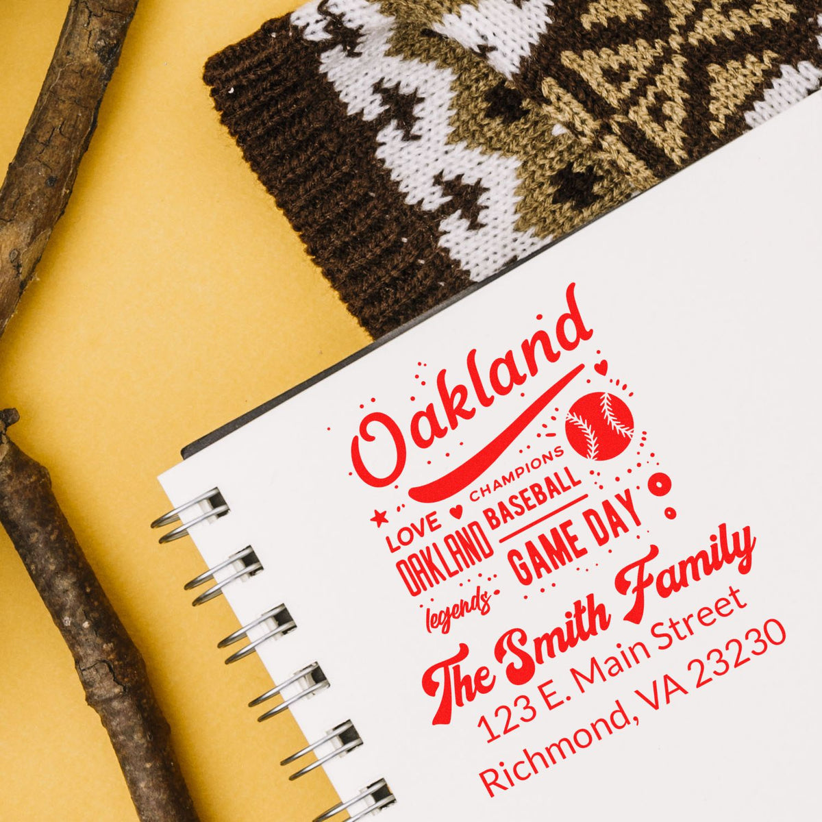 Custom rubber stamp design for Oakland baseball fans, with family name, Game Day text, and address details on a notebook.