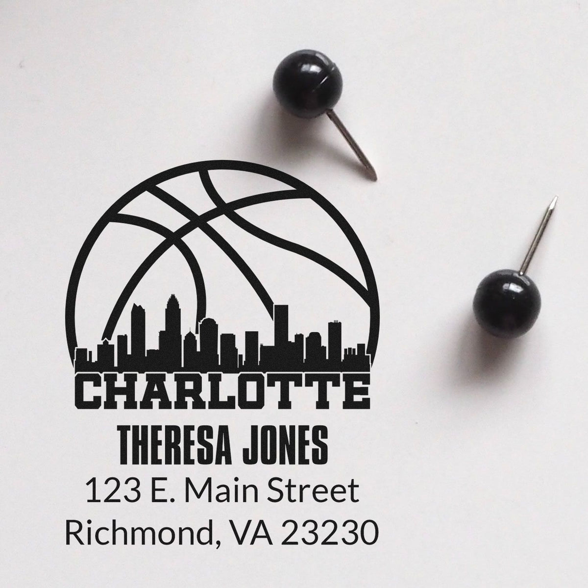 Custom basketball-themed rubber stamp impression with Charlotte skyline, Theresa Jones name, and mailing address.