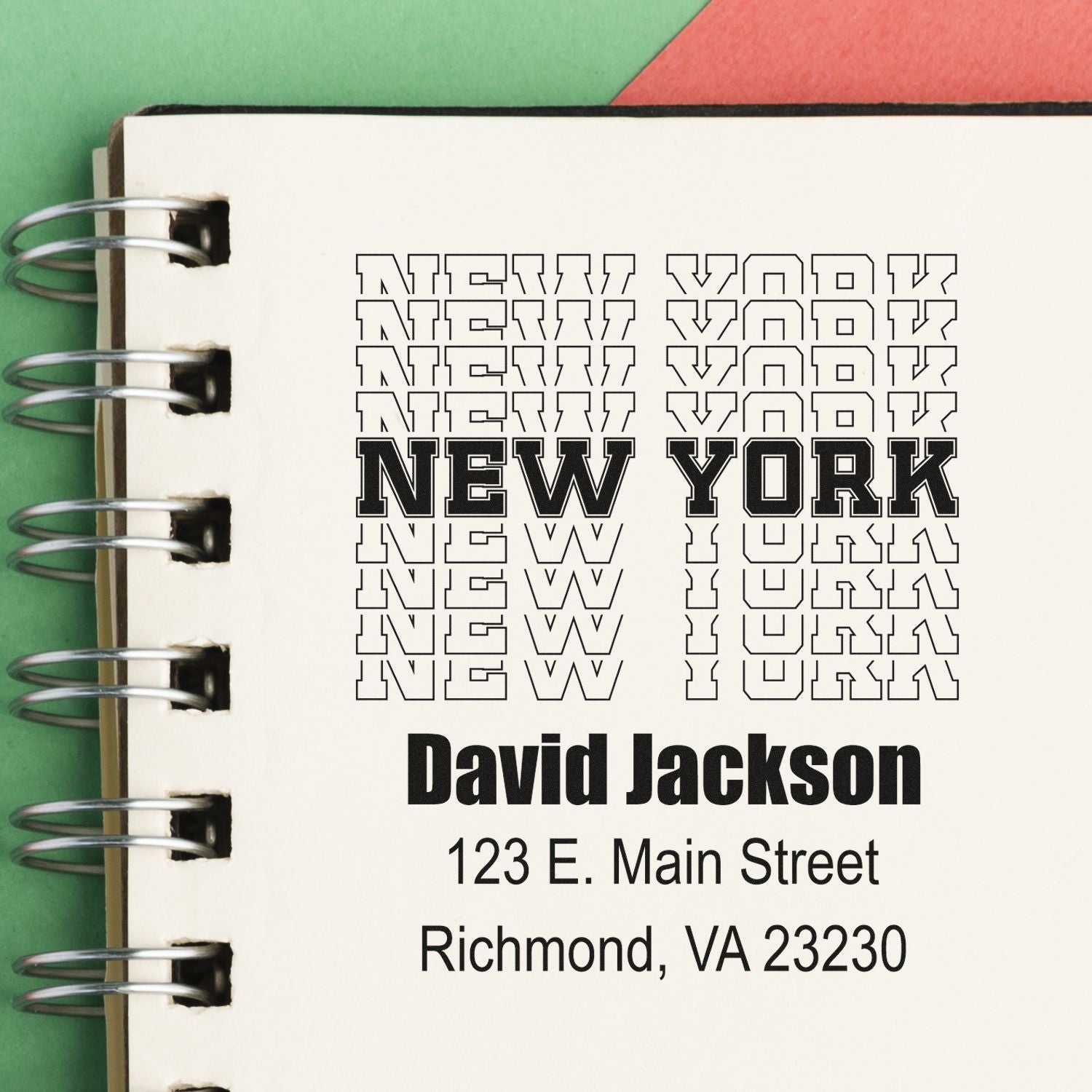 Custom rubber stamp mockup on notebook featuring New York text, name, and address for personalized address stamping.