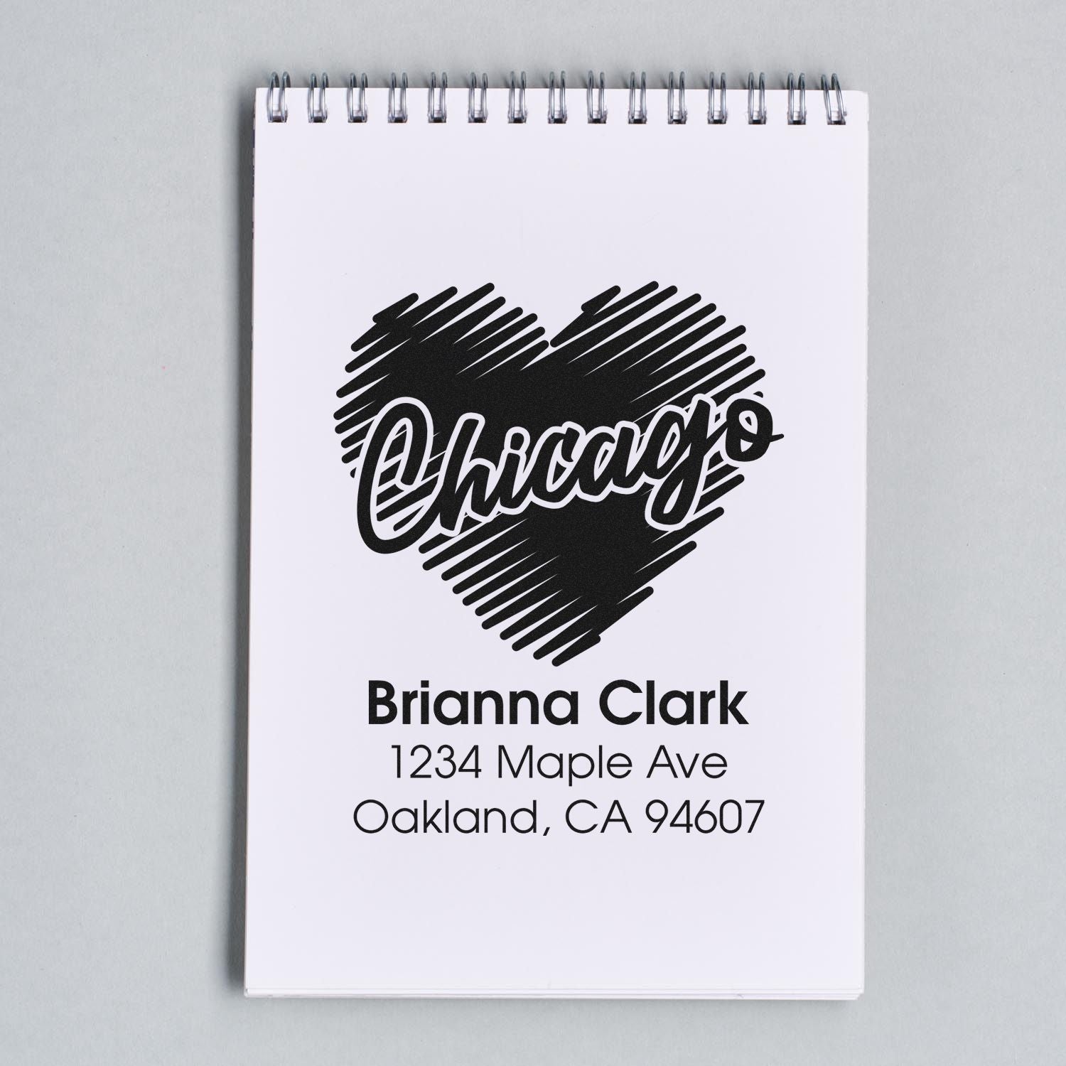 Custom Chicago heart rubber stamp with Brianna Clark address, personalized return address stamp design on notebook.