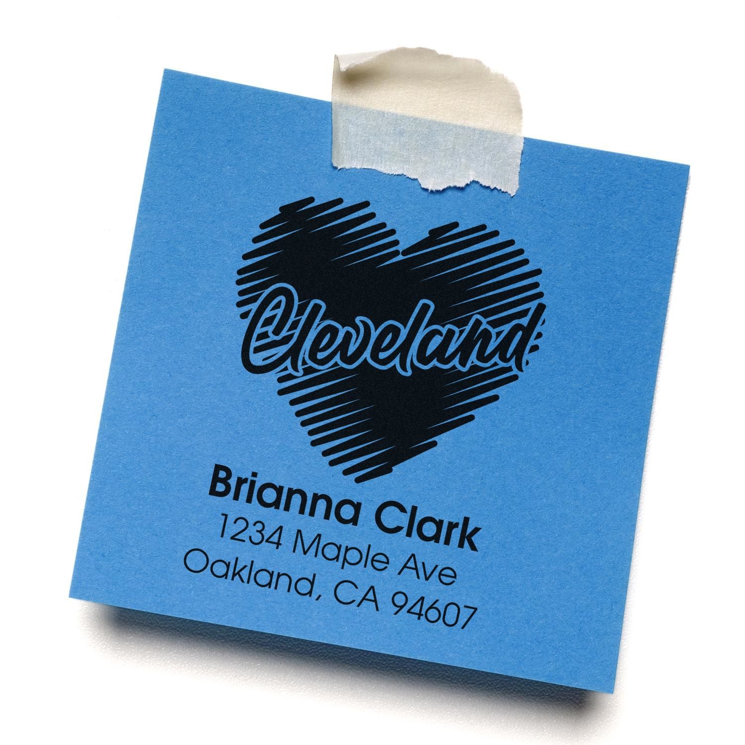 Personalized Cleveland return address rubber stamp with name, street, city and ZIP on blue paper.